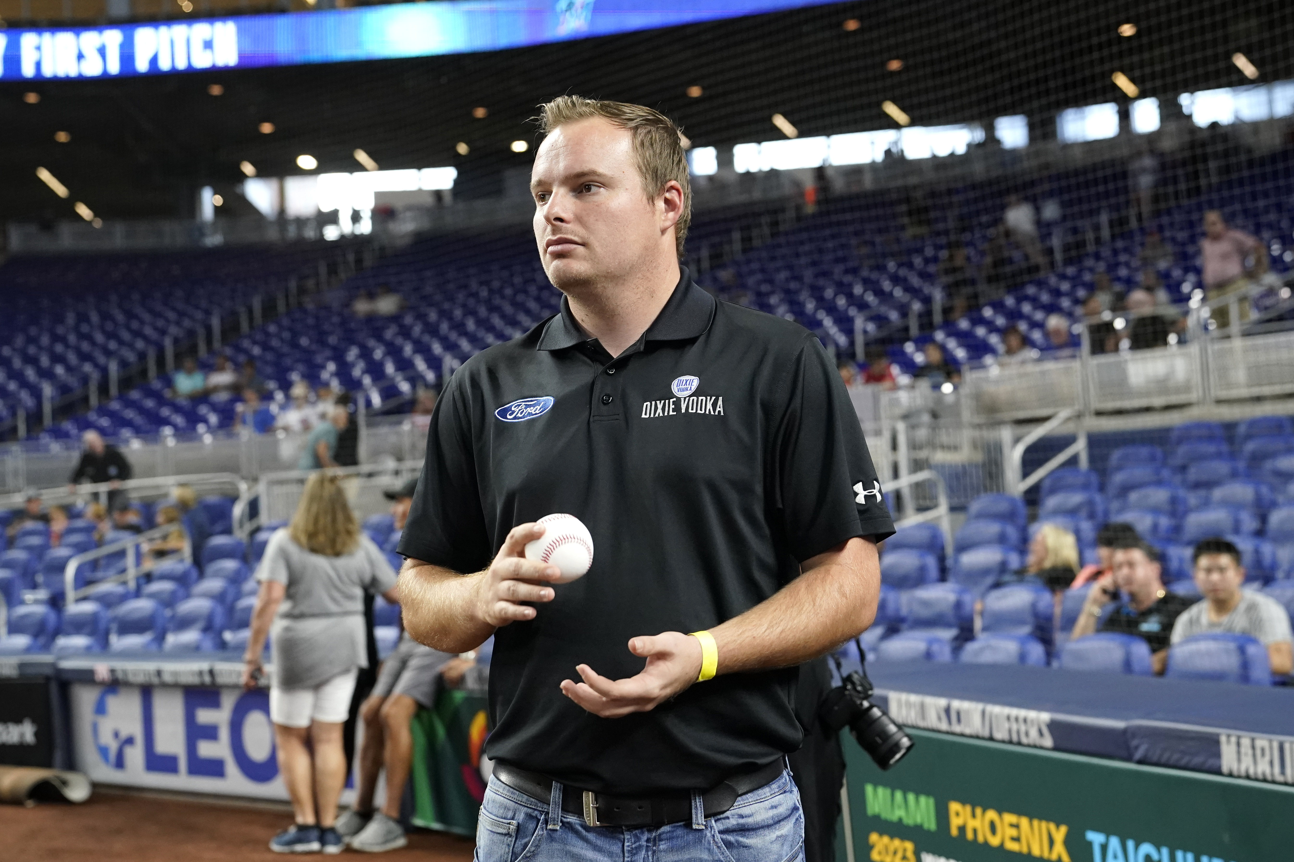NASCAR driver Cole Custer holds a baseball before throwing a ceremonial pitch before a baseball game between the Miami Marlins and Chicago Cubs, Monday, Sept. 19, 2022, in Miami. 