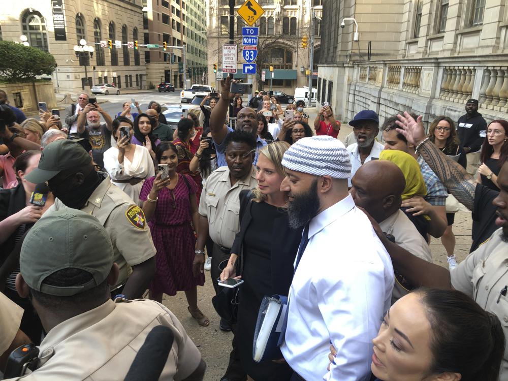 Adnan Syed, center, leaves the Cummings Courthouse on Sept. 19, in Baltimore. A judge has ordered the release of Syed on Tuesday after overturning his conviction for a 1999 murder that was chronicled in the hit podcast "Serial."