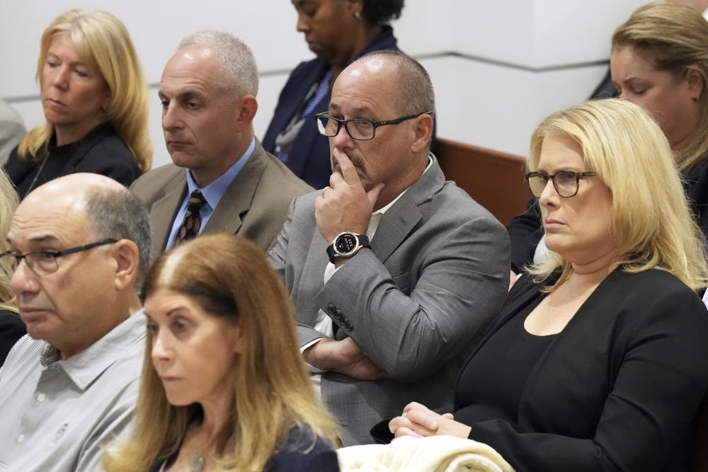 Fred and Jennifer Guttenberg are shown seated with family members of the victims as Assistant State Attorney Mike Satz details the killings in his closing arguments in the penalty phase of the trial of Marjory Stoneman Douglas High School shooter Nikolas Cruz at the Broward County Courthouse in Fort Lauderdale, Fla. on Tuesday. The Guttenberg's daughter, Jaime, was killed in the 2018 shootings.