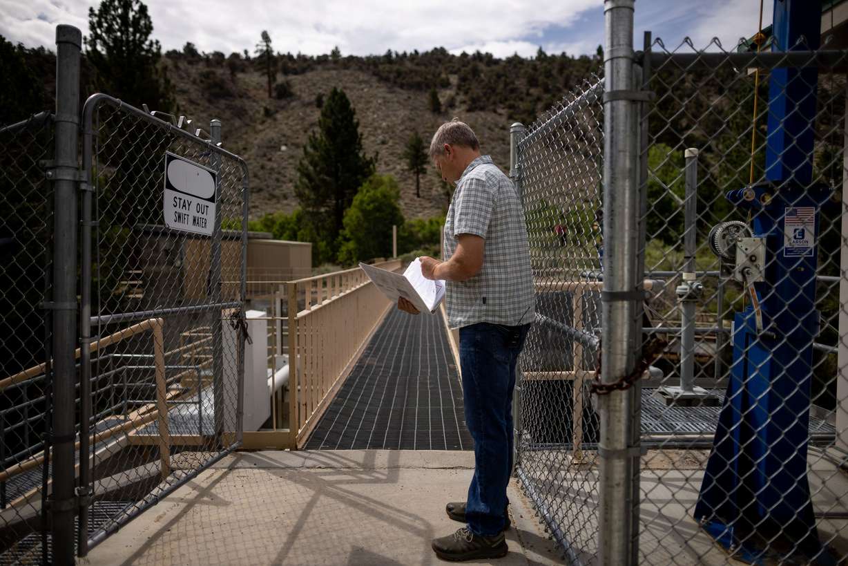 Geoffrey McQuilkin, executive director of the Mono Lake Committee, shows journalists the gates that are used to divert water from Lee Vining Creek to serve Los Angeles on Aug. 9.