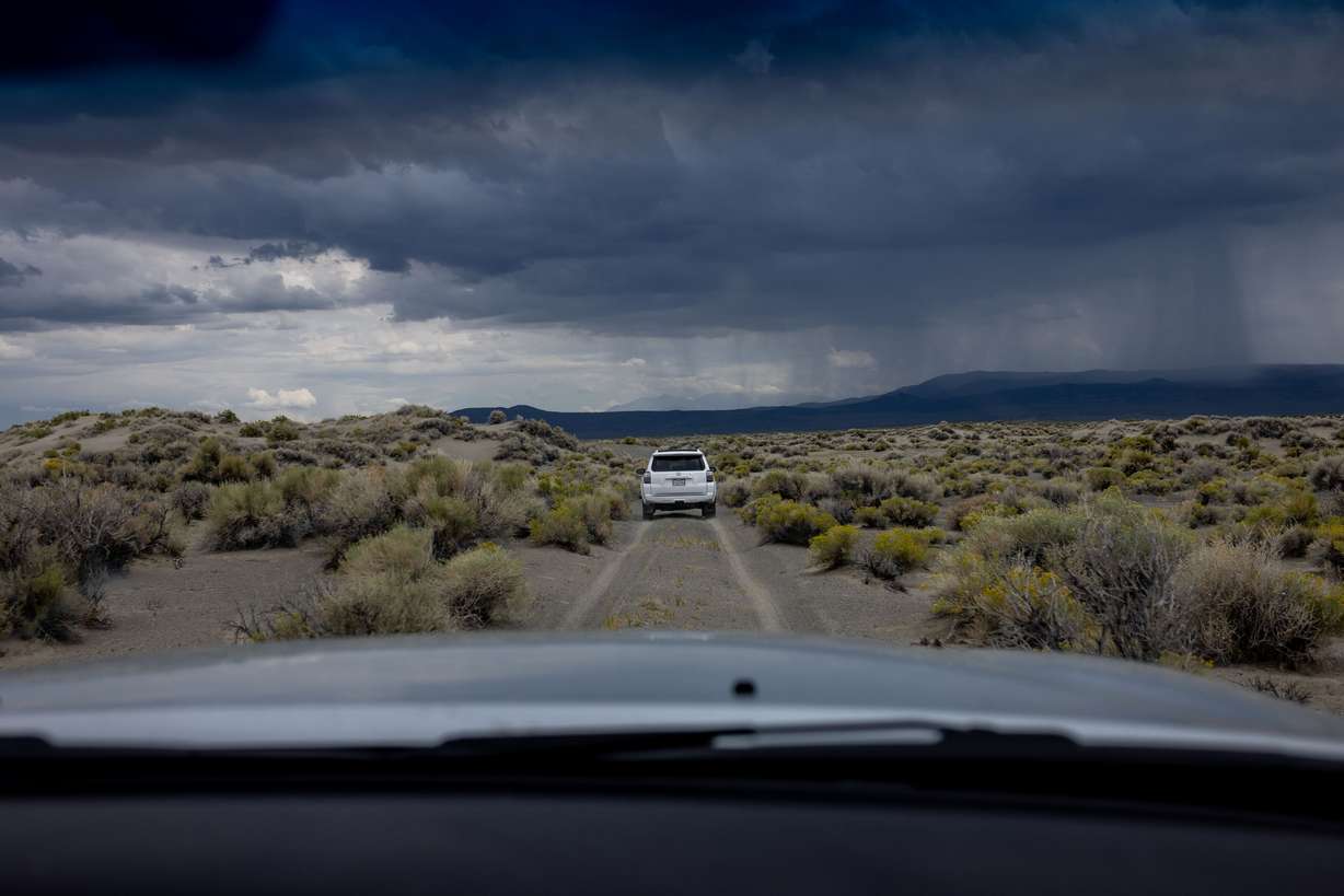 Phill Kiddoo, air pollution control officer for the Great Basin Unified Air Pollution Control District, pilots his car ahead of Geoffrey McQuilkin, executive director of the Mono Lake Committee, while they take journalists to see an air quality monitoring site on the north shore of Mono Lake in Mono County, Calif., on Aug. 9.