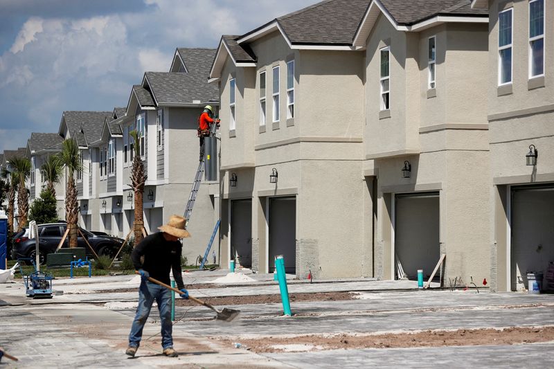 A carpenter works on building new townhomes that are still under construction in Tampa, Fla., May 5, 2021. The average interest rate on the most popular U.S. home loan rose to its highest level since 2006, data showed Wednesday.