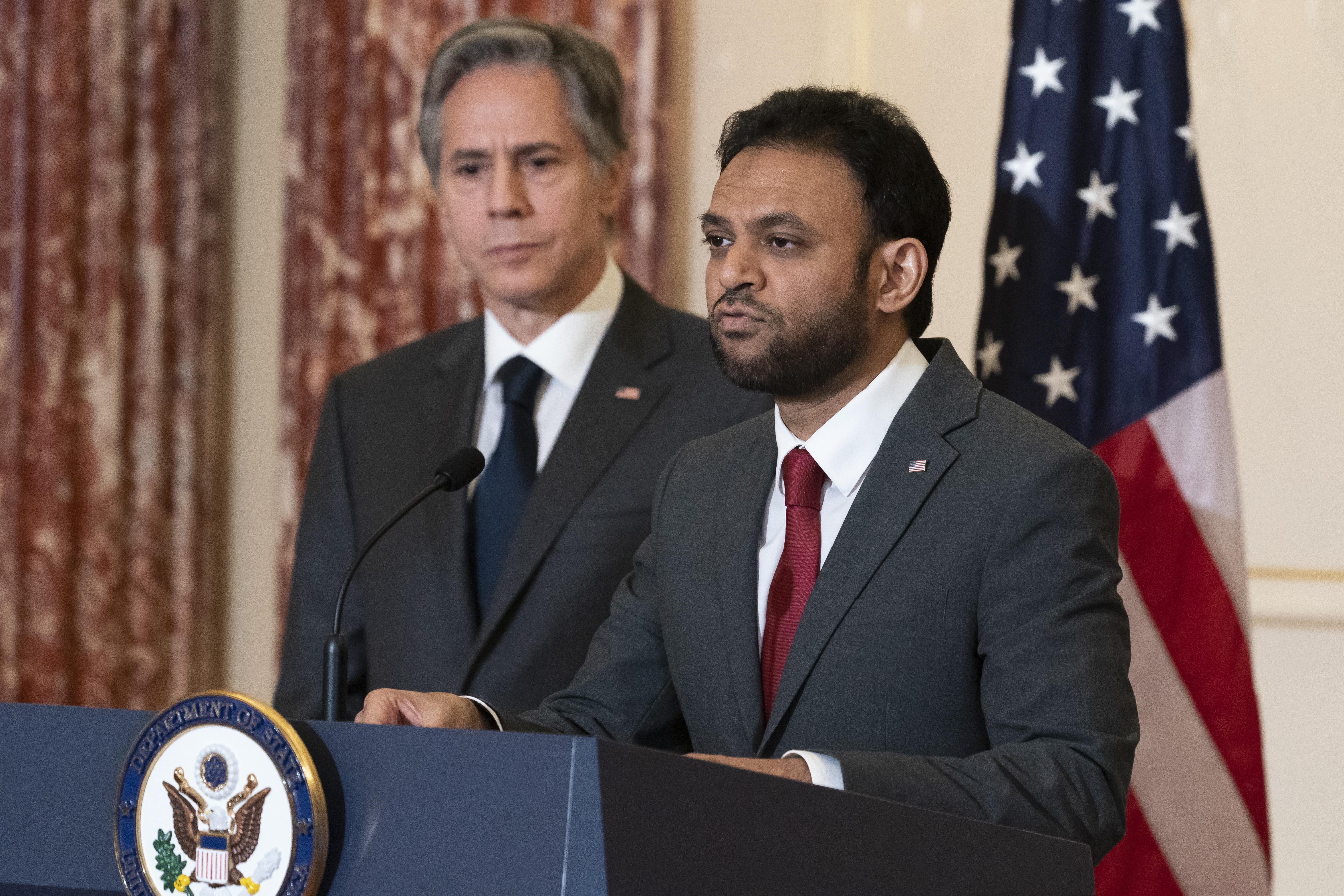 Secretary of State Antony Blinken, left, listens as Ambassador at Large for International Religious Freedom Rashad Hussain speaks on the release of the 2021 International Religious Freedom Report, at the State Department, on June 2, in Washington. 