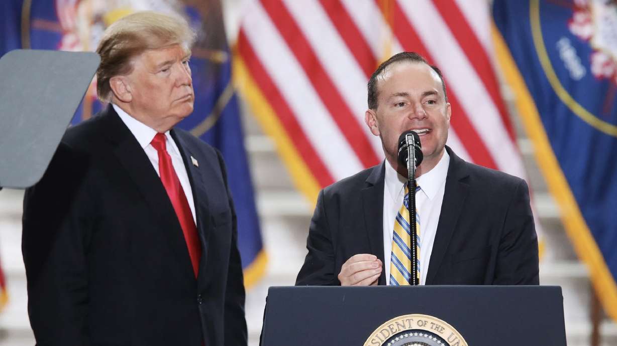 Sen. Mike Lee, R-Utah, speaks as President Donald Trump looks on at the Capitol in Salt Lake City on Dec. 4, 2017. Trump weighed in on Lee’s reelection bid this week.