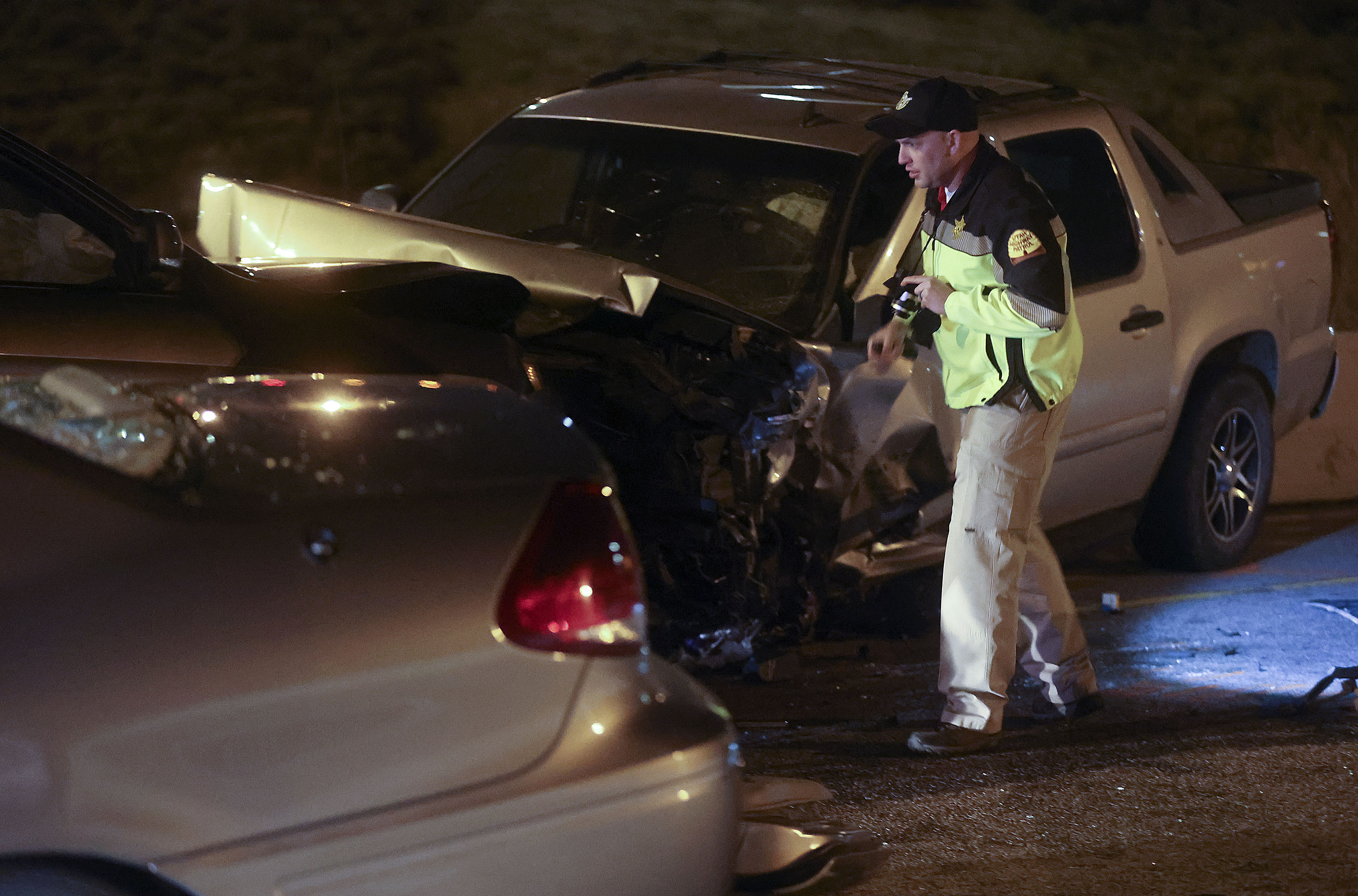 Utah Highway Patrol troopers at the scene of a wrong-way crash involving three vehicles on I-215 in Murray on April 19, 2021. The driver of the wrong-way vehicle was sentenced to prison Wednesday for killing a woman in the crash.