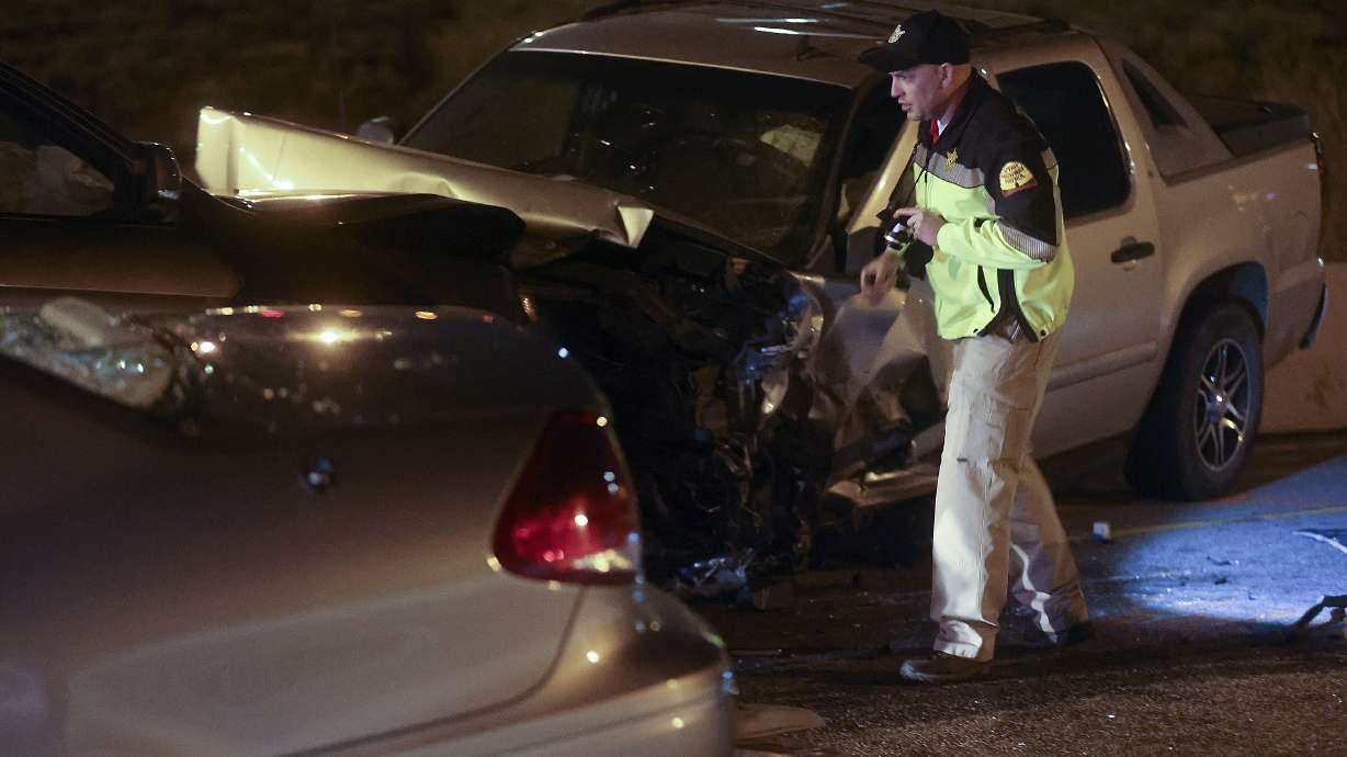 Utah Highway Patrol troopers at the scene of a wrong-way crash involving three vehicles on I-215 in Murray on April 19, 2021. The driver of the wrong-way vehicle was sentenced to prison Wednesday for killing a woman in the crash.
