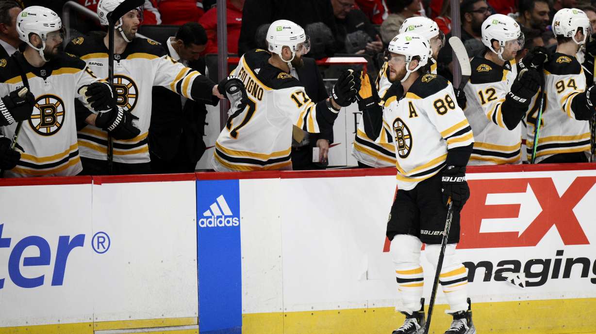 Boston Bruins right wing David Pastrnak (88) is congratulated for his goal during the first period of the team's NHL hockey game against the Washington Capitals, Wednesday, Oct. 12, 2022, in Washington.