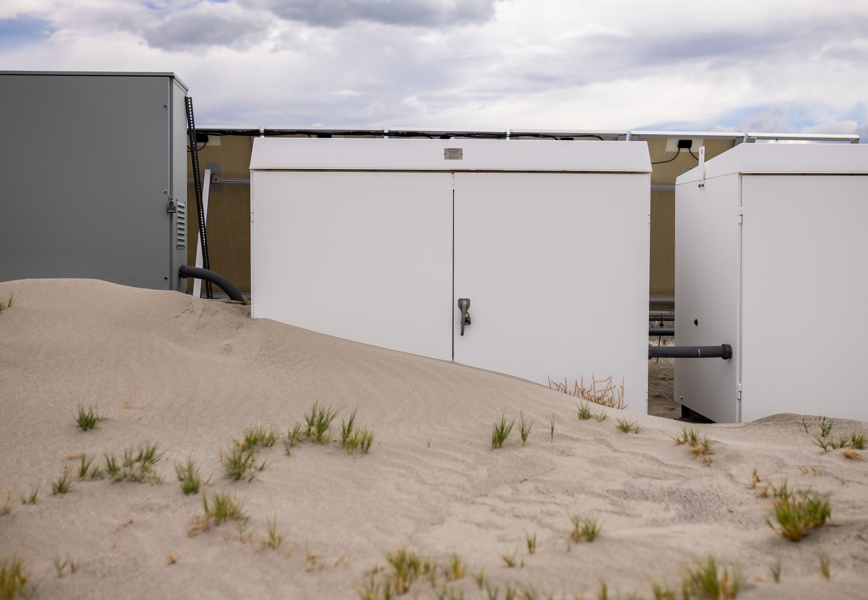 Sand dunes overtake equipment that is part of an air quality monitoring site on the north shore of Mono Lake in Mono County, California, on Tuesday, Aug. 9.
