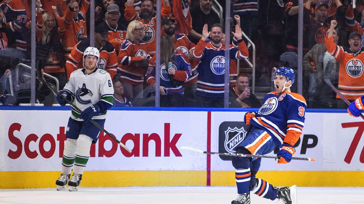 Edmonton Oilers' Connor McDavid (97) celebrates a goal against the Vancouver Canucks during the third period of an NHL hockey game Wednesday, Oct. 12, 2022, in Edmonton, Alberta.