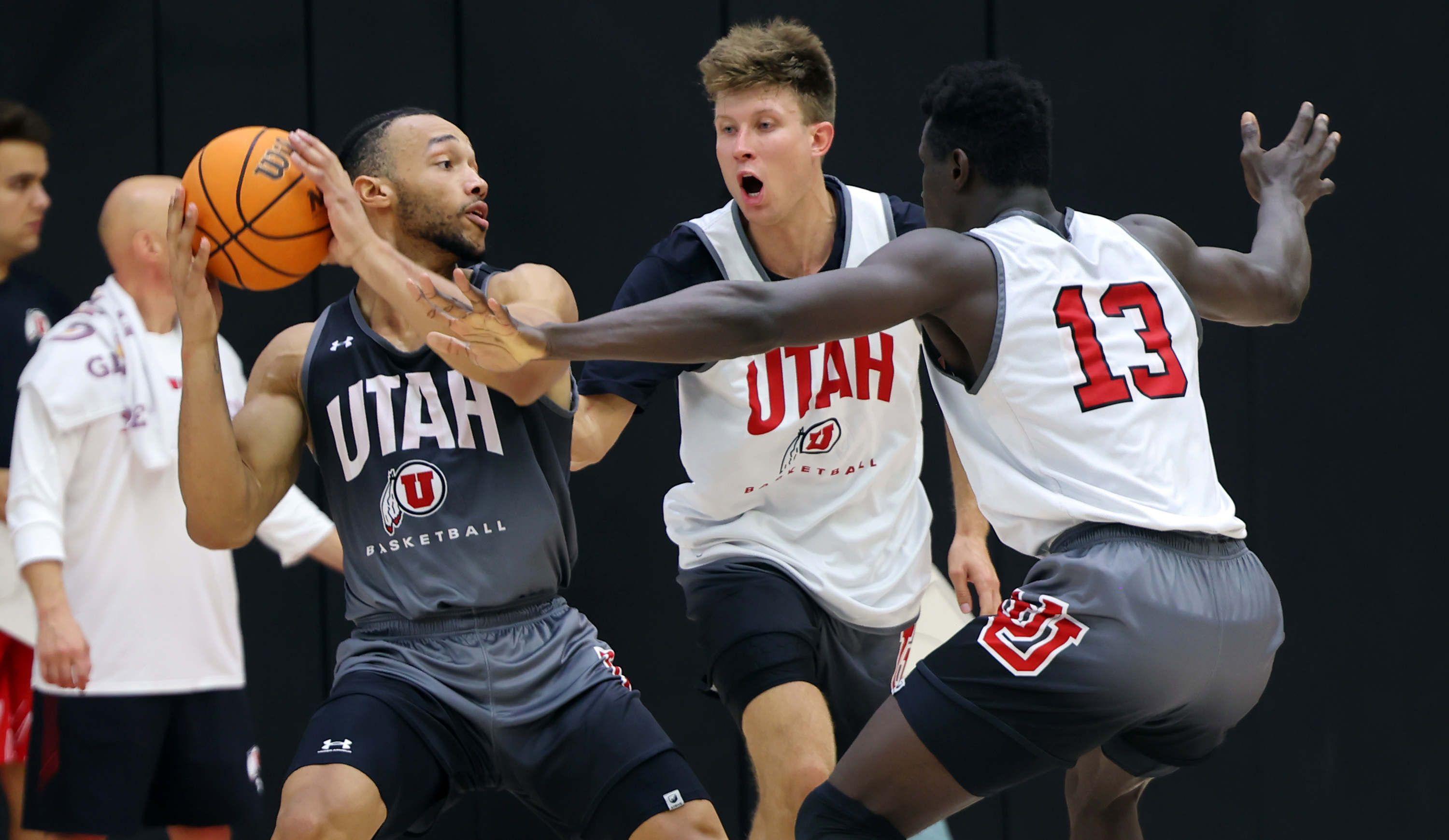 Marco Anthony looks for help as he is defended by Eli Ballstaedt and Keba Keita as the University of Utah Men’s Basketball team opens camp with practice in the Jon M. and Karen Huntsman Basketball Facility in Salt Lake City on Monday, Sept. 26, 2022.