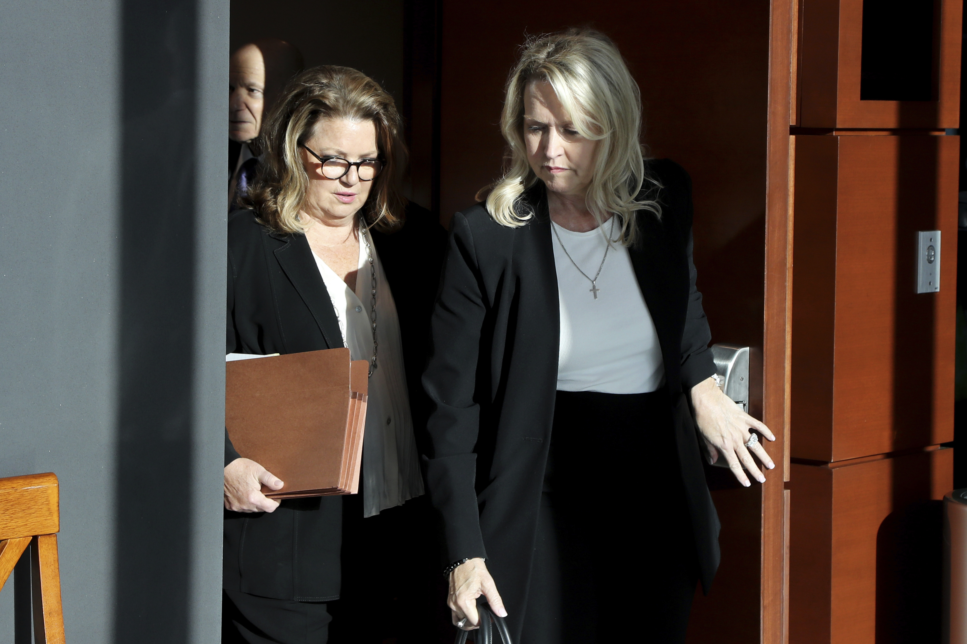 Assistant State Attorney Carolyn McCann, left, exits the courtroom along with Gena Hoyer as the jury begins their second day of deliberations in the Marjory Stoneman Douglas High School shooter Nikolas Cruz sentencing in Fort Lauderdale, Fla on Thursday. Hoyer's son, Luke, was killed in the 2018 shootings.