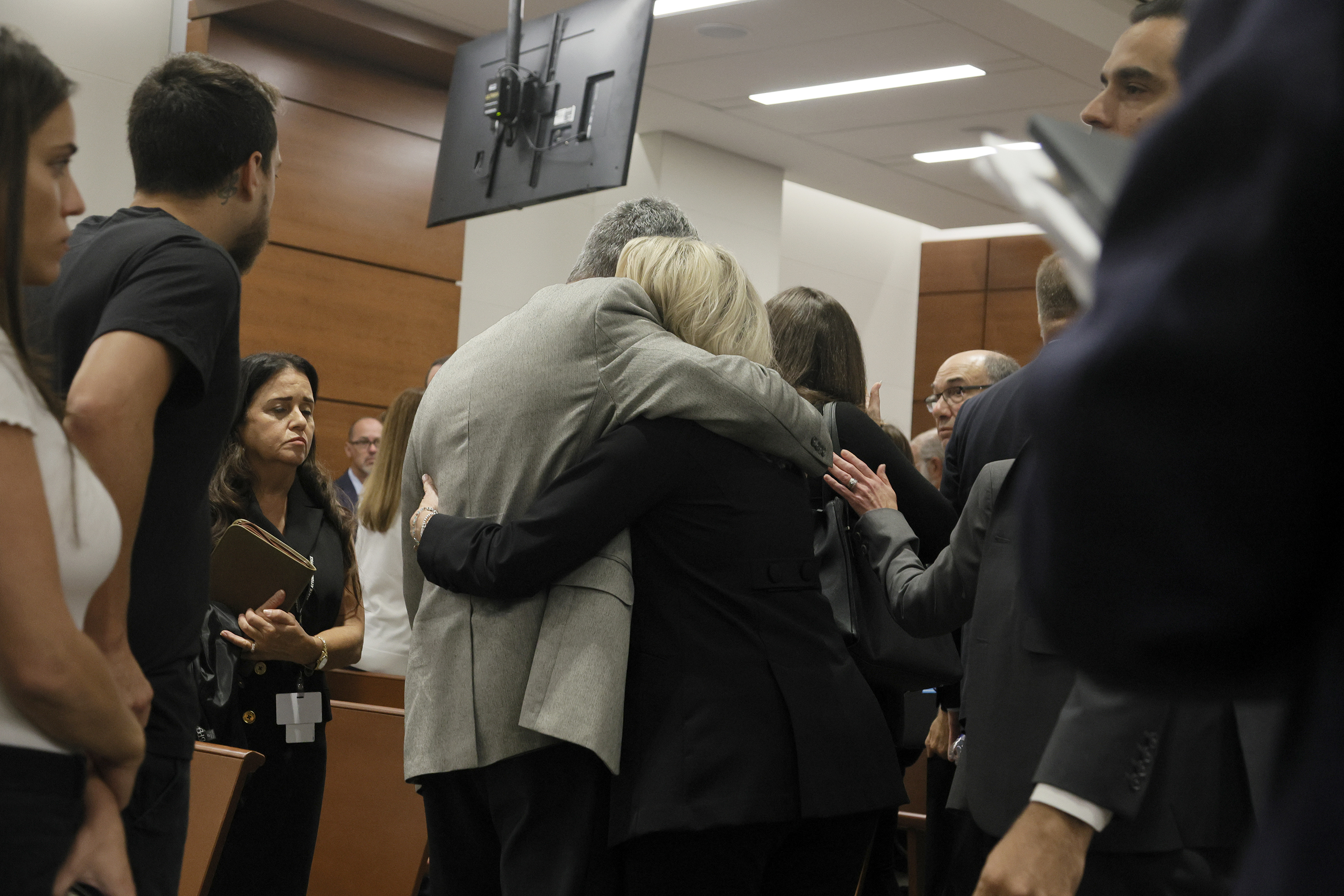 Tom and Gena Hoyer exit the courtroom as Gena could be heard sobbing following the verdict in the trial of Marjory Stoneman Douglas High School shooter Nikolas Cruz at the Broward County Courthouse in Fort Lauderdale, Fla., on Thursday. The Hoyer's son, Luke, was killed in the 2018 shootings.
