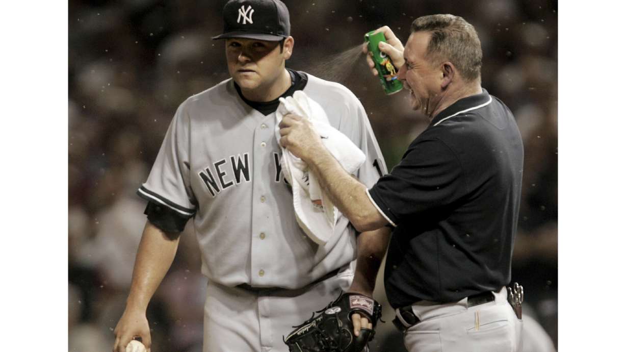FILE - New York Yankee head trainer Gene Monahan sprays New York Yankees pitcher Joba Chamberlain with bug spray as small insects swarm in the eighth inning of Game 2 of an American League Division Series baseball game against the Cleveland Indians, Friday, Oct. 5, 2007, in Cleveland. Their fans still bugged by what happened in 2007, the New York Yankees could face those pesky midges again when the American League Division Series returns to Cleveland this weekend.