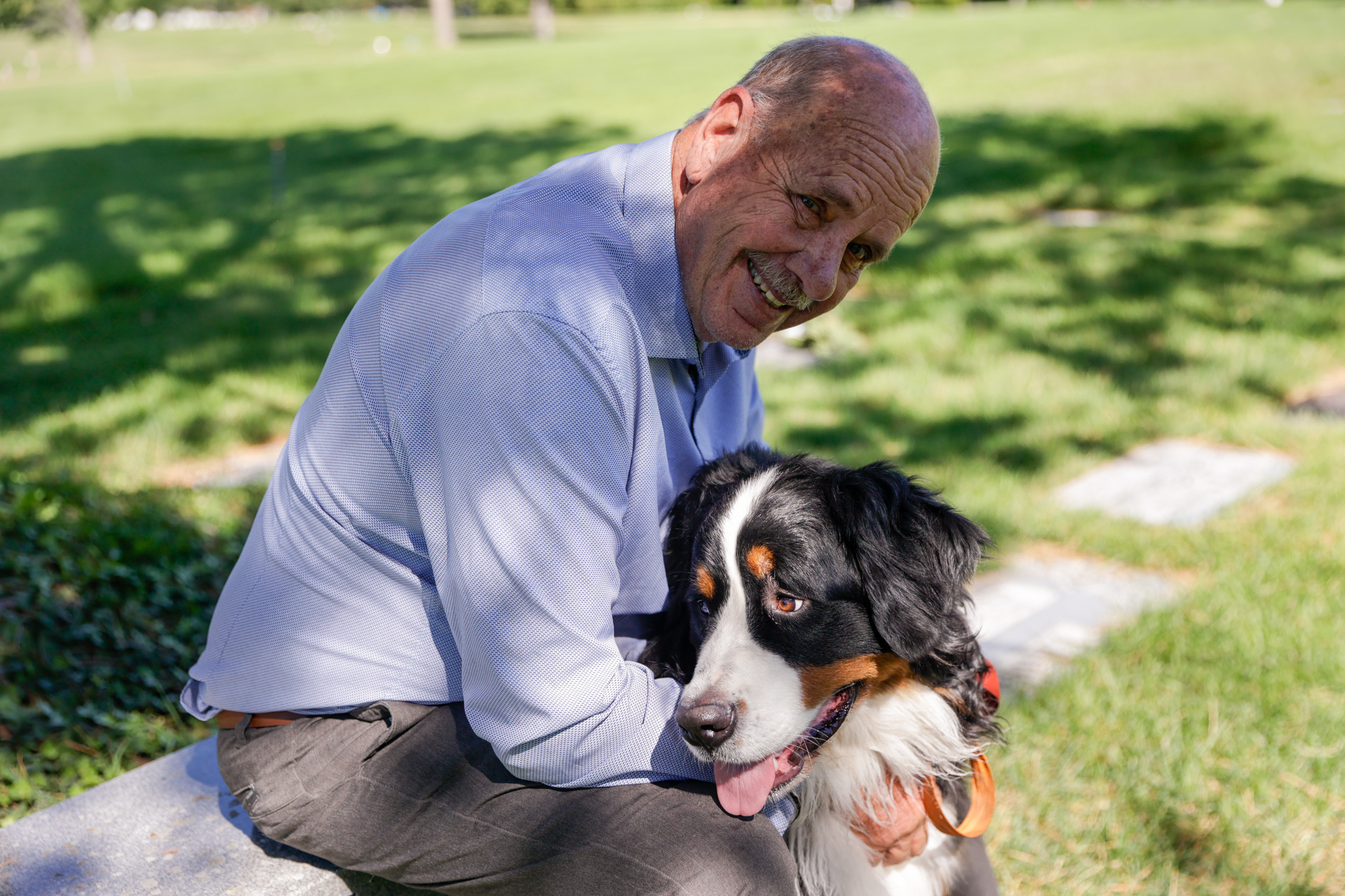 Ron Snarr sits for a portrait with his dog Otto as he looks at his sons' graves at Wasatch Lawn Memorial Park and Mortuary in Millcreek on Sunday, Aug. 28. Snarr’s sons, Levi and Zachary, are buried next to one another.