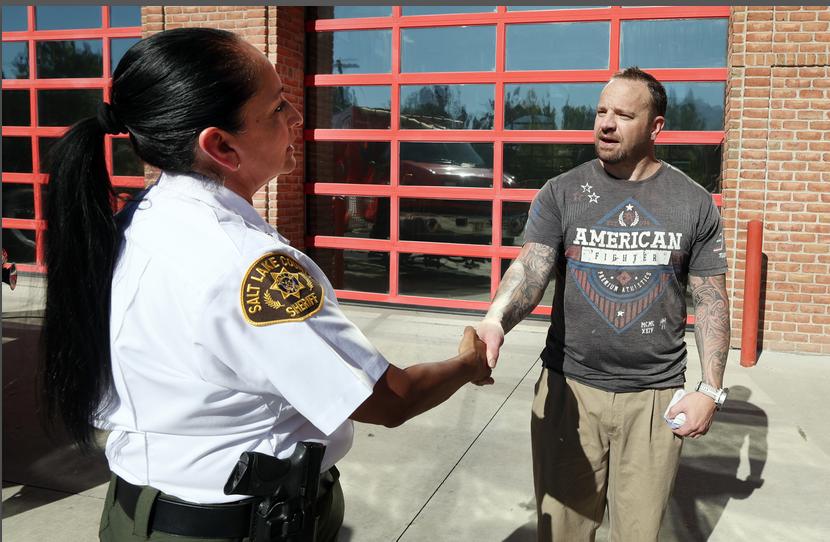 Salt Lake County Sheriff Rosie Rivera thanks Chris Lovell, a recovering drug addict, for warning the public about the dangers of fentanyl-laced drugs on Friday. The sheriff's office is concerned about "rainbow fentanyl" being marketed by drug dealers toward young people. 