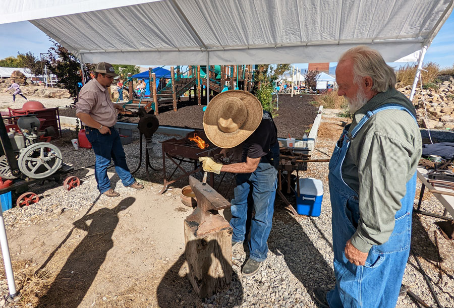 Carson Pate, Kirt Davis and Neil Davis teach a blacksmithing class.