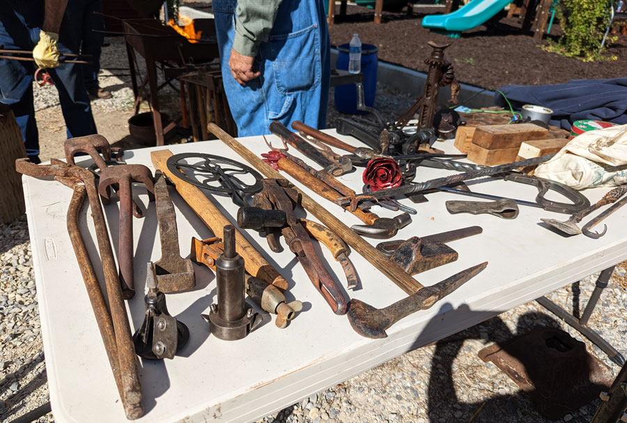 A display of the types of work students complete under the tutelage of Kirt and Neil Davis. Axes, knives and saws are popular.