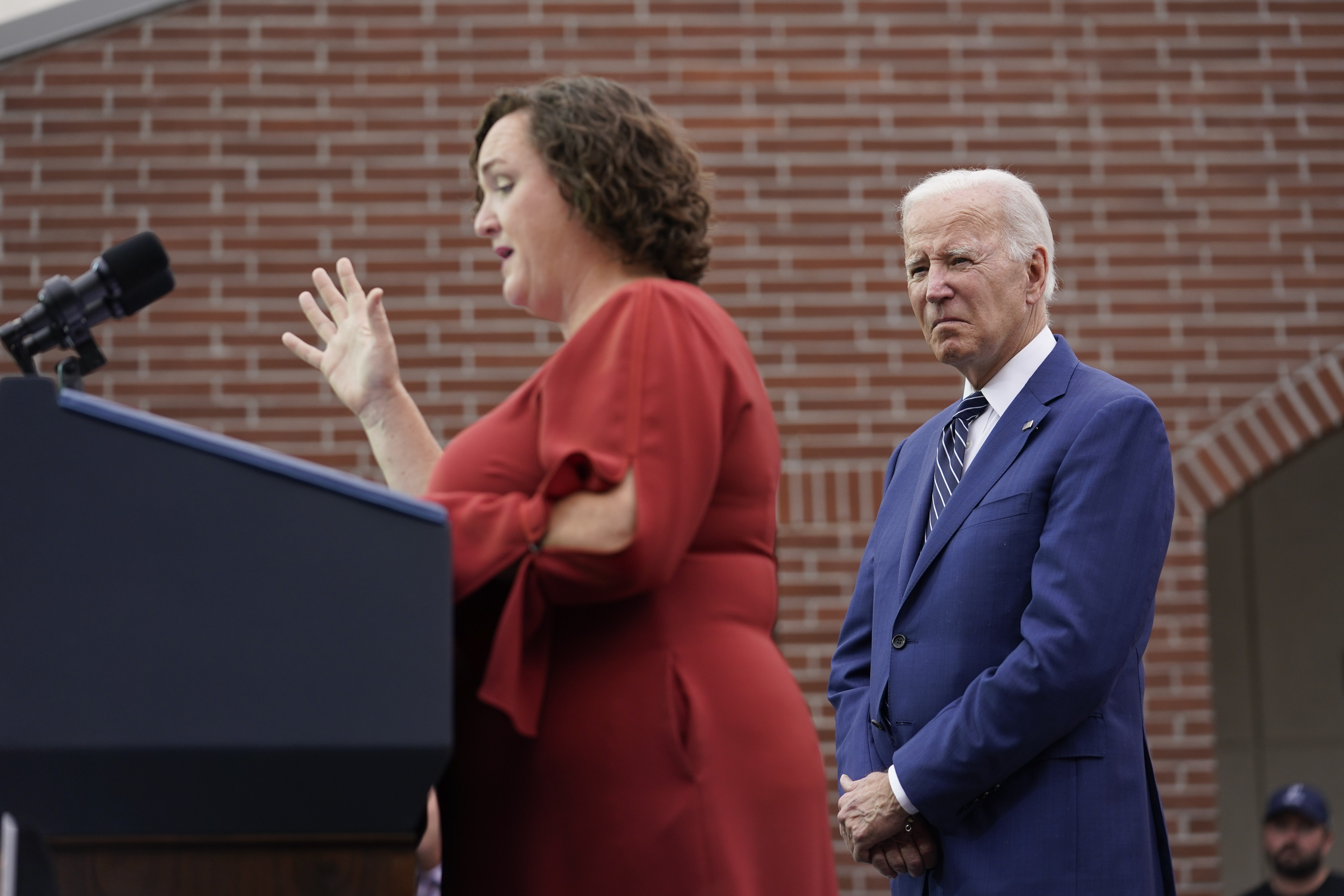 President Joe Biden listens as Rep. Katie Porter, D-Calif., speaks at Irvine Valley Community College, in Irvine, California on Friday.