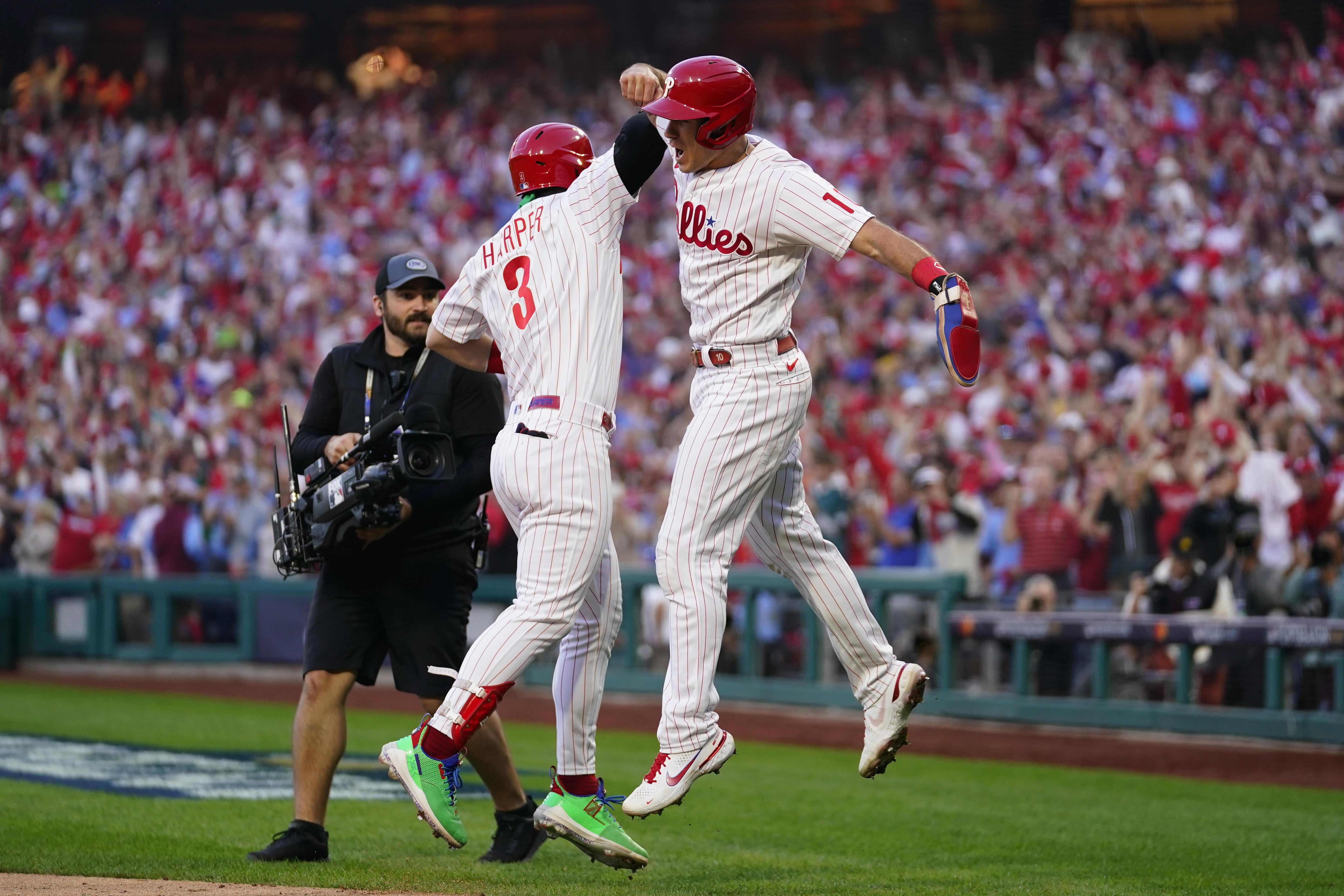 Philadelphia Phillies' Rhys Hoskins (17) celebrates with Bryce Harper (3) after hitting a three-run home run during the third inning in Game 3 of baseball's National League Division Series against the Atlanta Braves, Friday, Oct. 14, 2022, in Philadelphia. 
