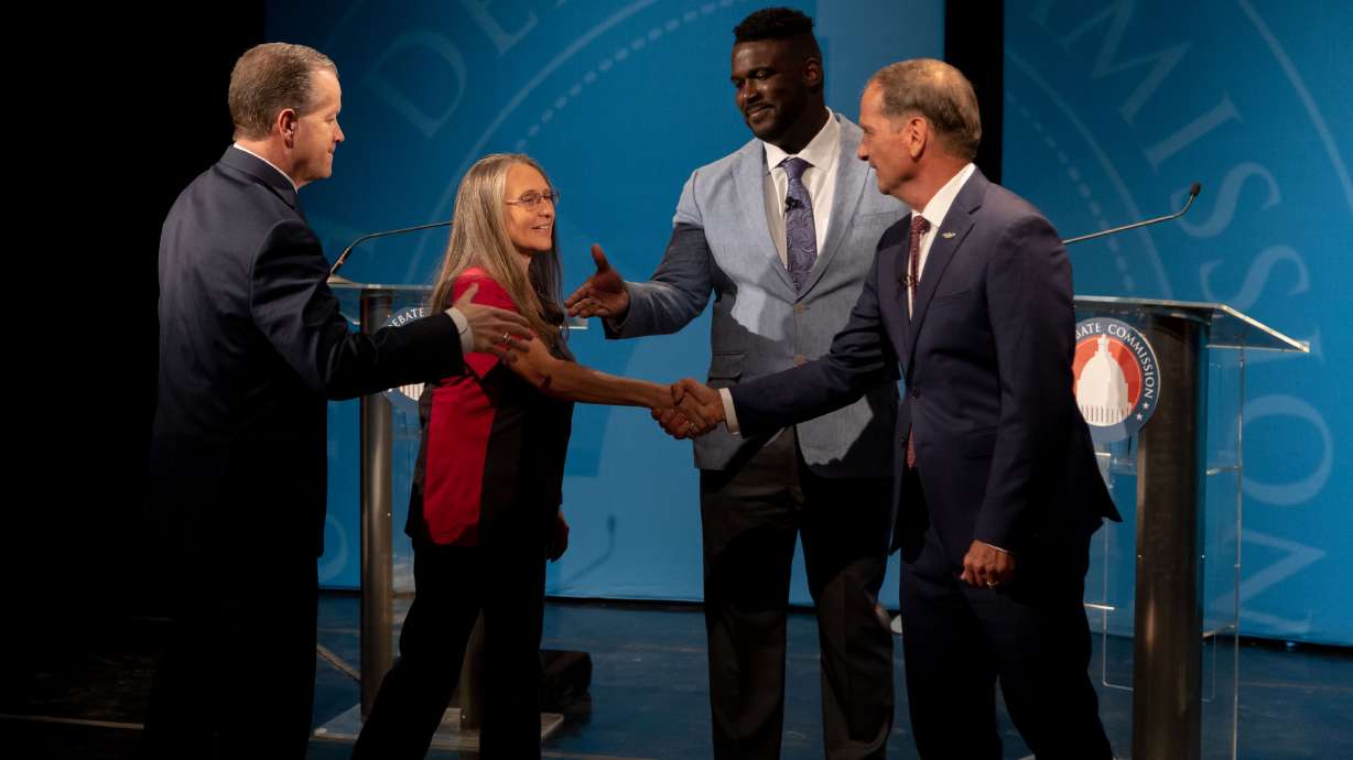 Congressional candidates Chris Stewart, Nick Mitchell and Cassie Easley shake hands before the 2nd District congressional debate in Cedar City Friday night.