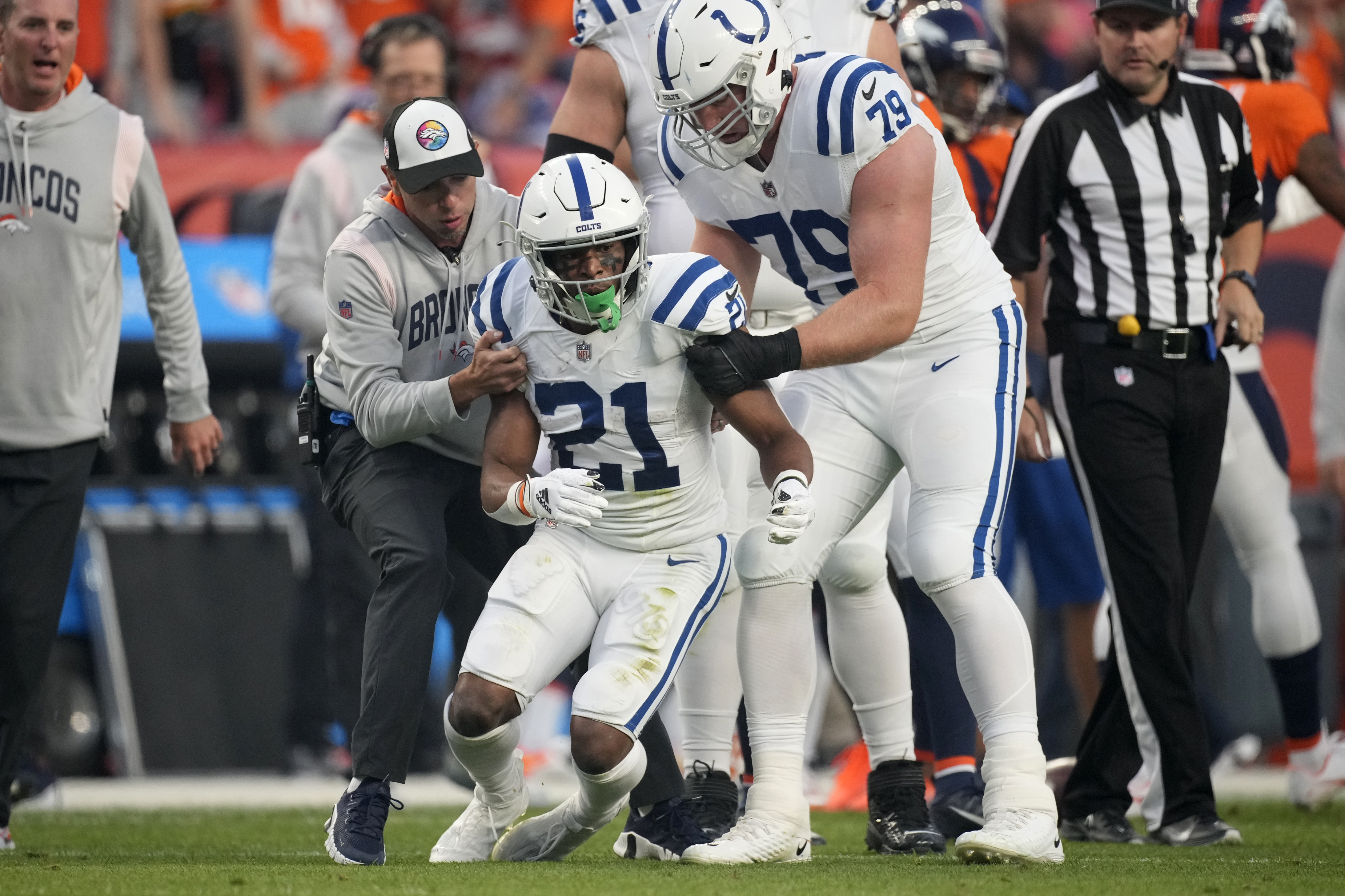 Indianapolis Colts running back Nyheim Hines (21) stumbles as he tries to get up after being injured against the Denver Broncos during the first half of an NFL football game, Thursday, Oct. 6, 2022, in Denver.