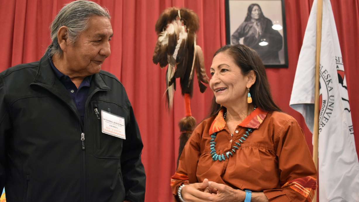 Russell Eagle Bear, with the Rosebud Sioux Reservation Tribal Council, talks to U.S. Interior Secretary Deb Haaland during a meeting about Native American boarding schools at Sinte Gleska University in Mission, S.D., Saturday. Haaland has been holding events across the nation to shed light on the abuse suffered by many Native American children forced to attend the government-backed schools.