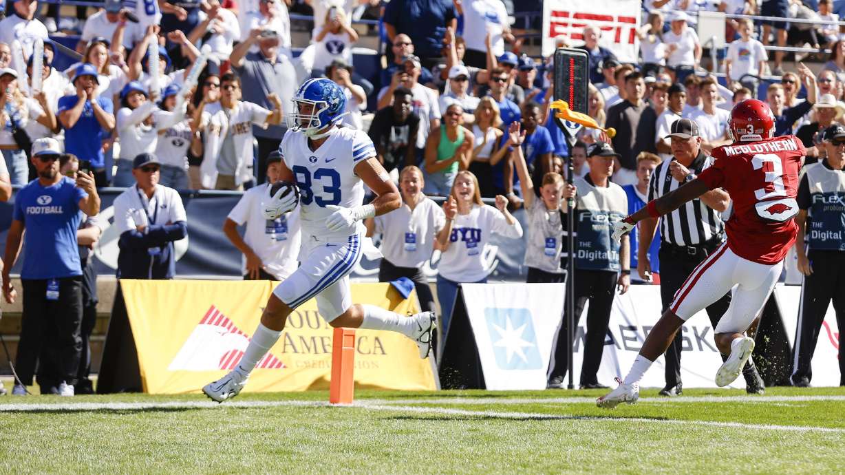 Isaac Rex (83) a tight end for the BYU Cougars runs the ball for a touchdown against the Arkansas Razorbacks in Provo on Saturday, Oct. 15, 2022.