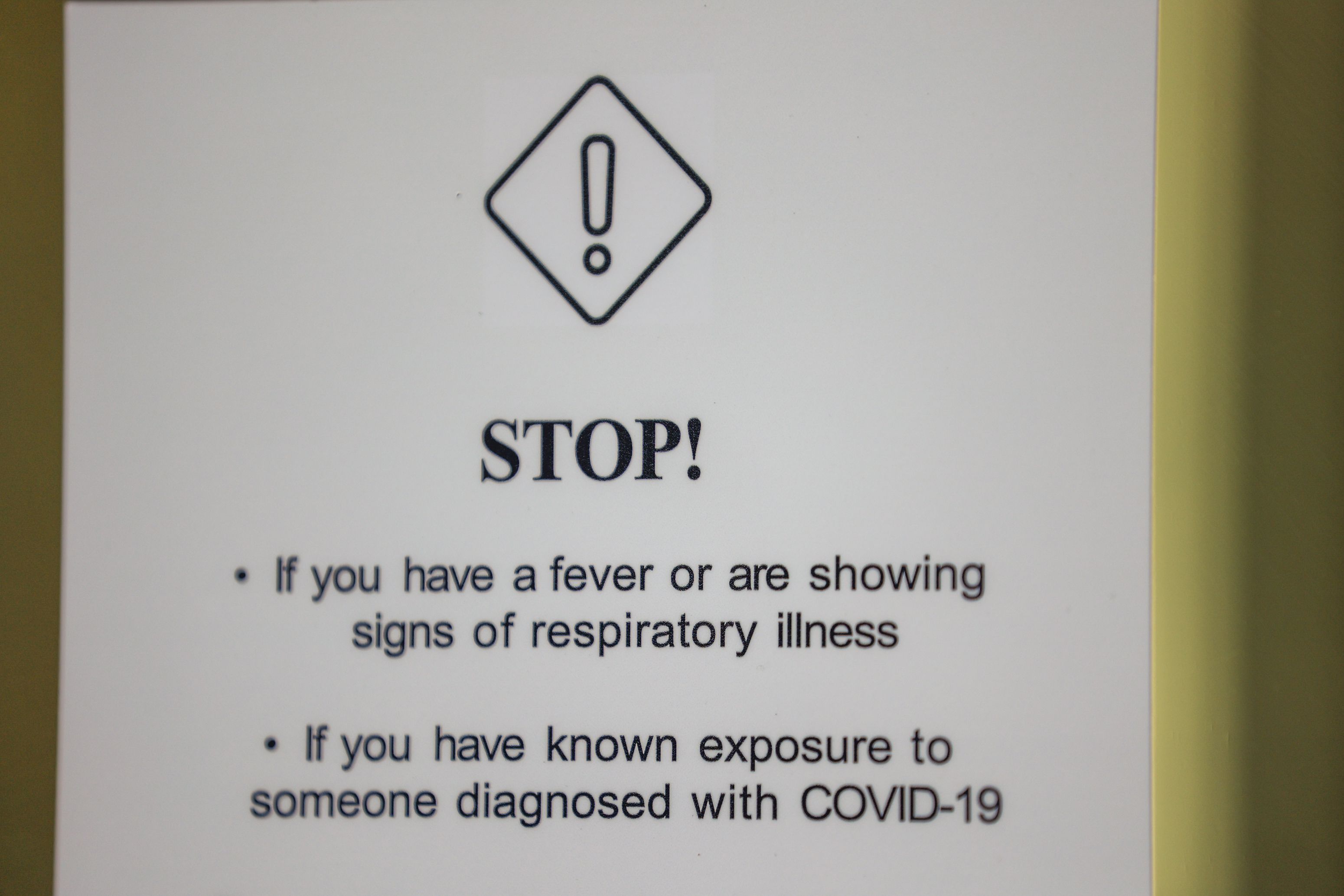 A sign detailing COVID-19 risks is posted on the front of the Clift Building in Salt Lake City on Oct. 10.