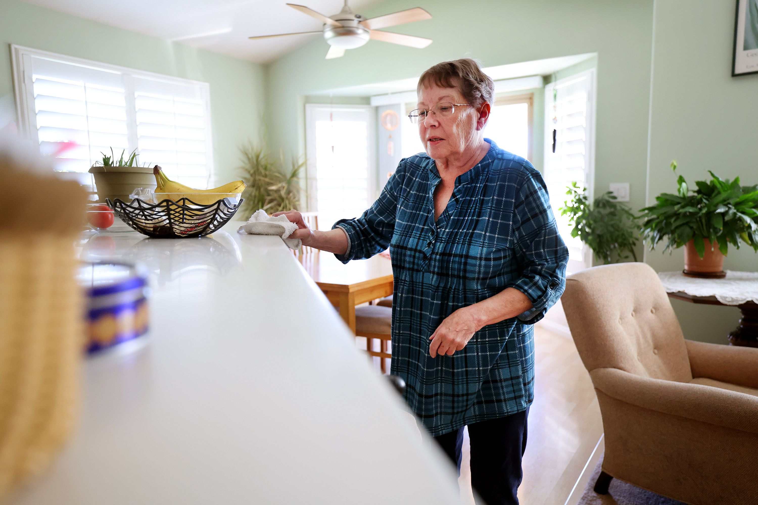 Barbara Person cleans her home in West Valley City on Friday. Person says she isn’t overly concerned with COVID-19 and this year’s flu season.