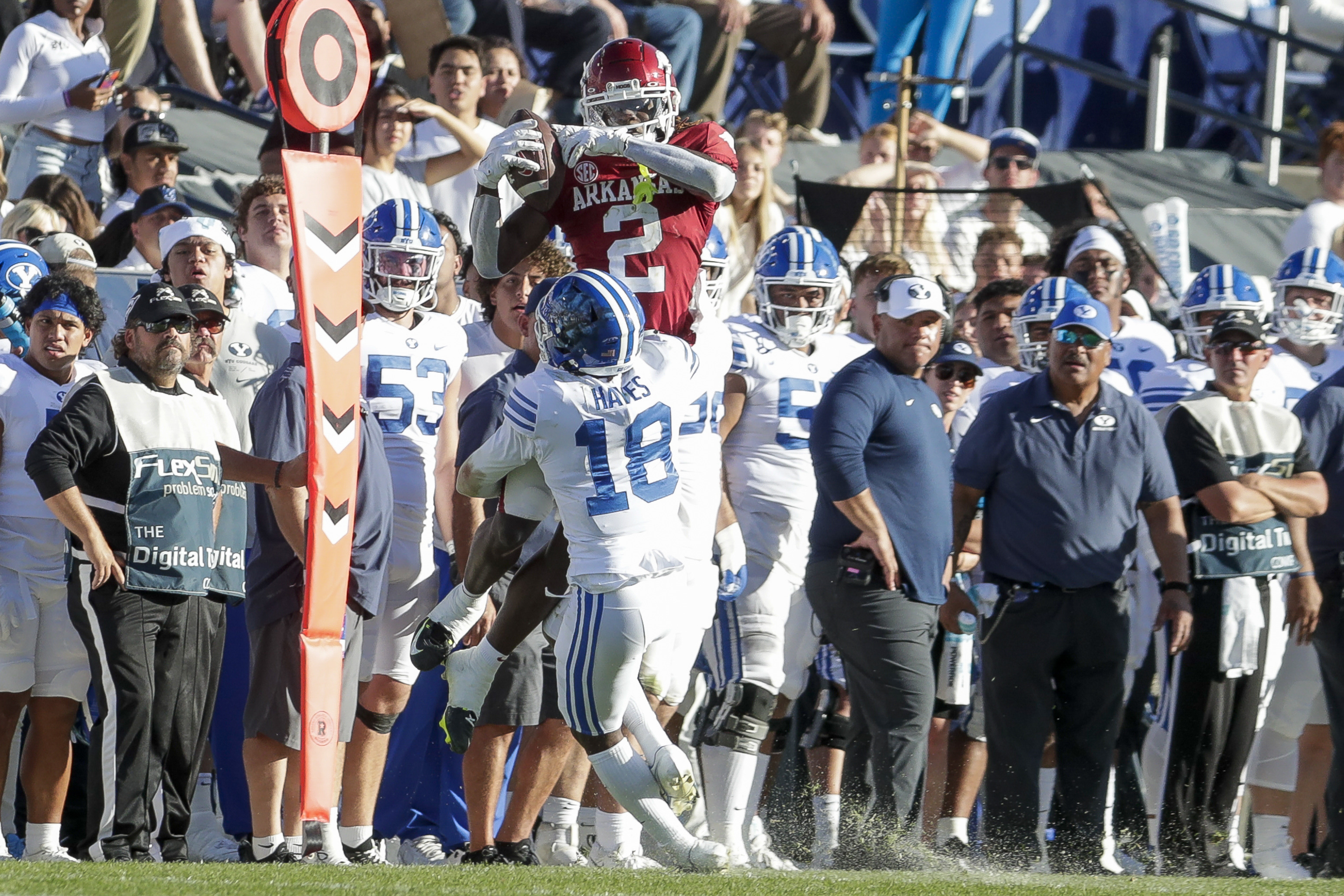 Arkansas wide receiver Ketron Jackson Jr. (2) catches the ball and is immediately tackled by BYU cornerback Kaleb Hayes (18) in Provo on Saturday, Oct. 15, 2022. The Razorbacks won 52-35.