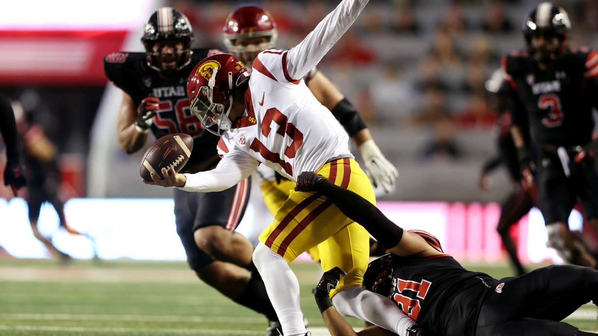 USC Trojans quarterback Caleb Williams (13) is sacked by Utah Utes defensive end Gabe Reid (91) as Utah and USC play at Rice Eccles Stadium in Salt Lake City on Saturday, Oct. 15, 2022.