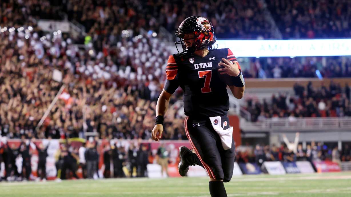 Utah Utes quarterback Cameron Rising (7) smiles as he runs into the end zone for a touchdown as Utah and USC play at Rice Eccles Stadium in Salt Lake City on Saturday, Oct. 15, 2022.