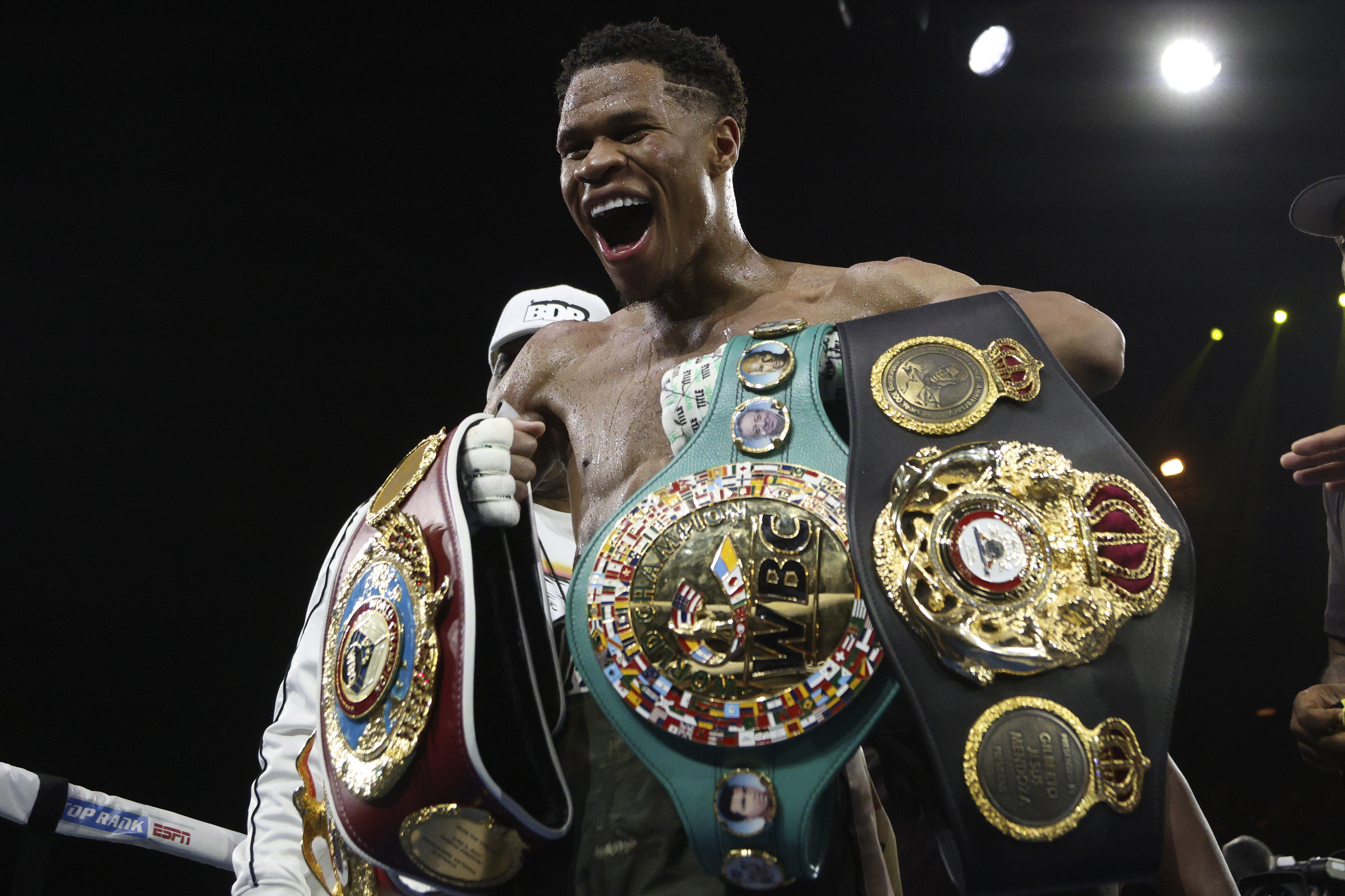 United States' Devin Haney displays his belts after defeating George Kambosos Jr. of Australia as Haney defends his undisputed lightweight boxing title in Melbourne, Sunday, Oct. 16, 2022.
