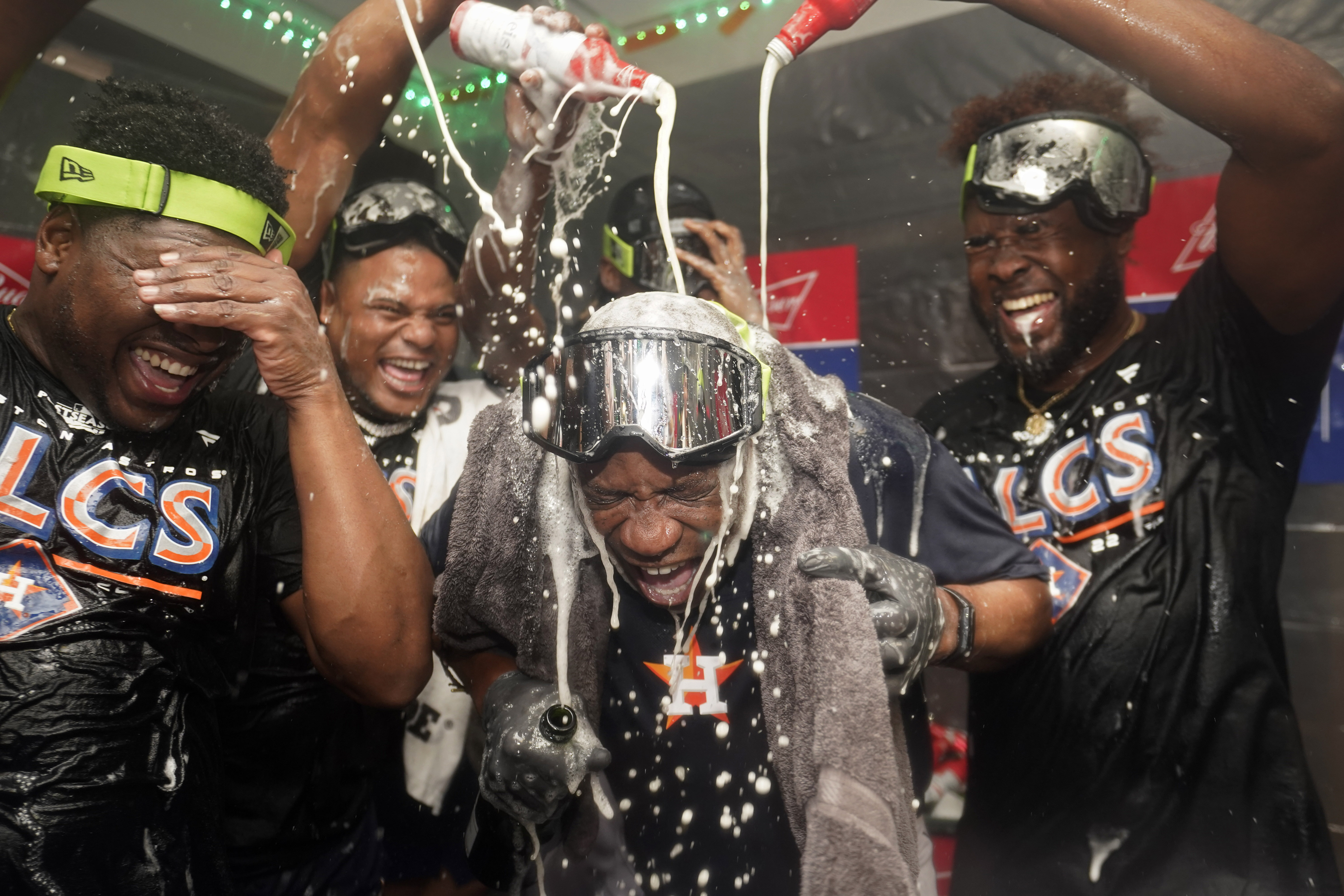 Houston Astros manager Dusty Baker Jr., center, celebrates with pitcher Hector Neris, left, and pitcher Cristian Javier, right, after defeating the Seattle Mariners in Game 3 of an American League Division Series baseball game Saturday, Oct. 15, 2022, in Seattle.