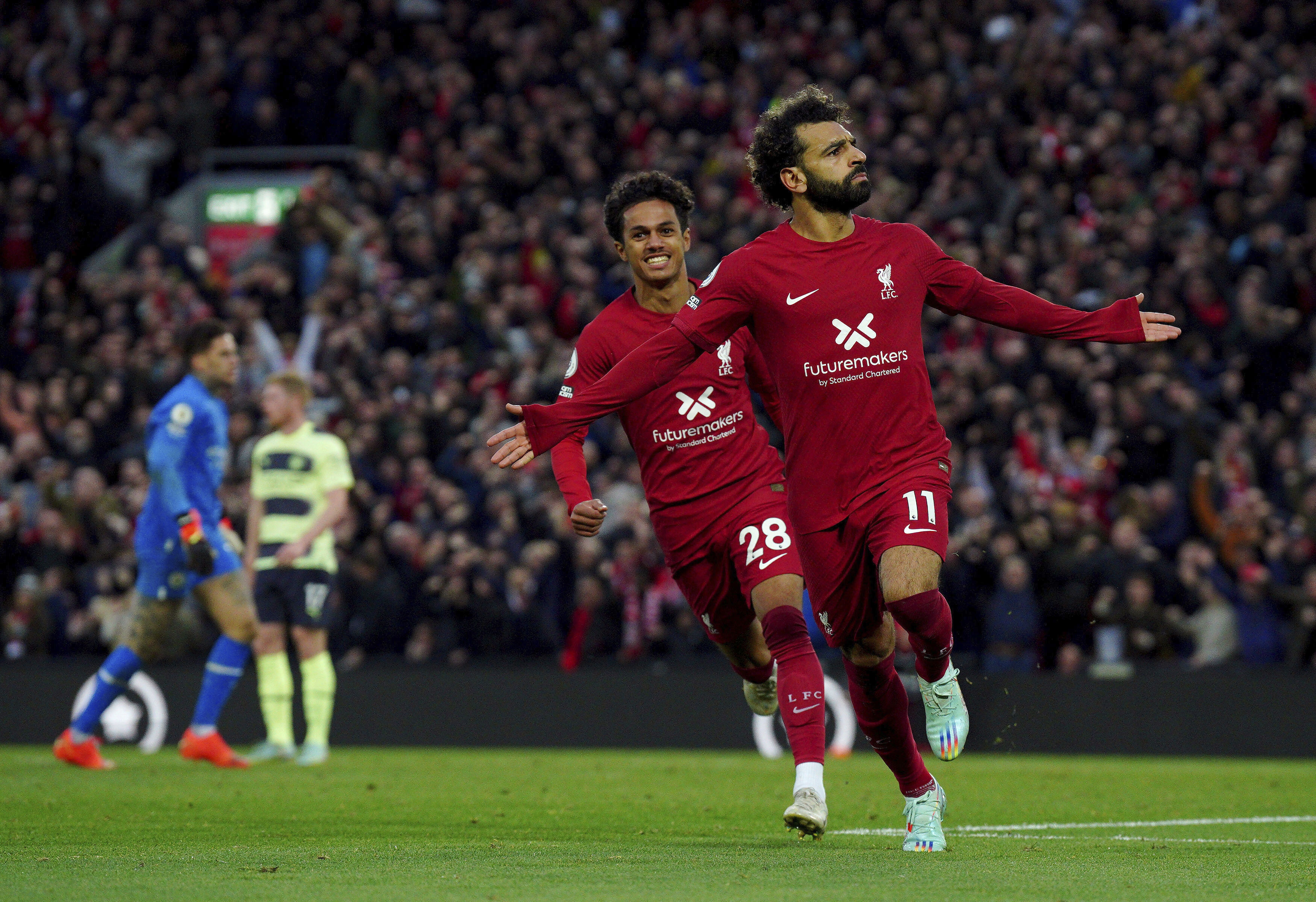 Liverpool's Mohamed Salah celebrates after scoring his side's opening goal during the English Premier League soccer match between Liverpool and Manchester City at Anfield stadium in Liverpool, Sunday, Oct. 16, 2022. 
 