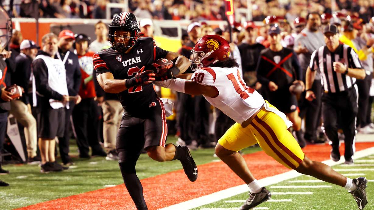 Utah Utes running back Micah Bernard (2) is shoved out of bounds by USC Trojans linebacker Ralen Goforth (10) as Utah and USC play at Rice Eccles Stadium in Salt Lake City on Saturday, Oct. 15, 2022. Utah won 43-42.