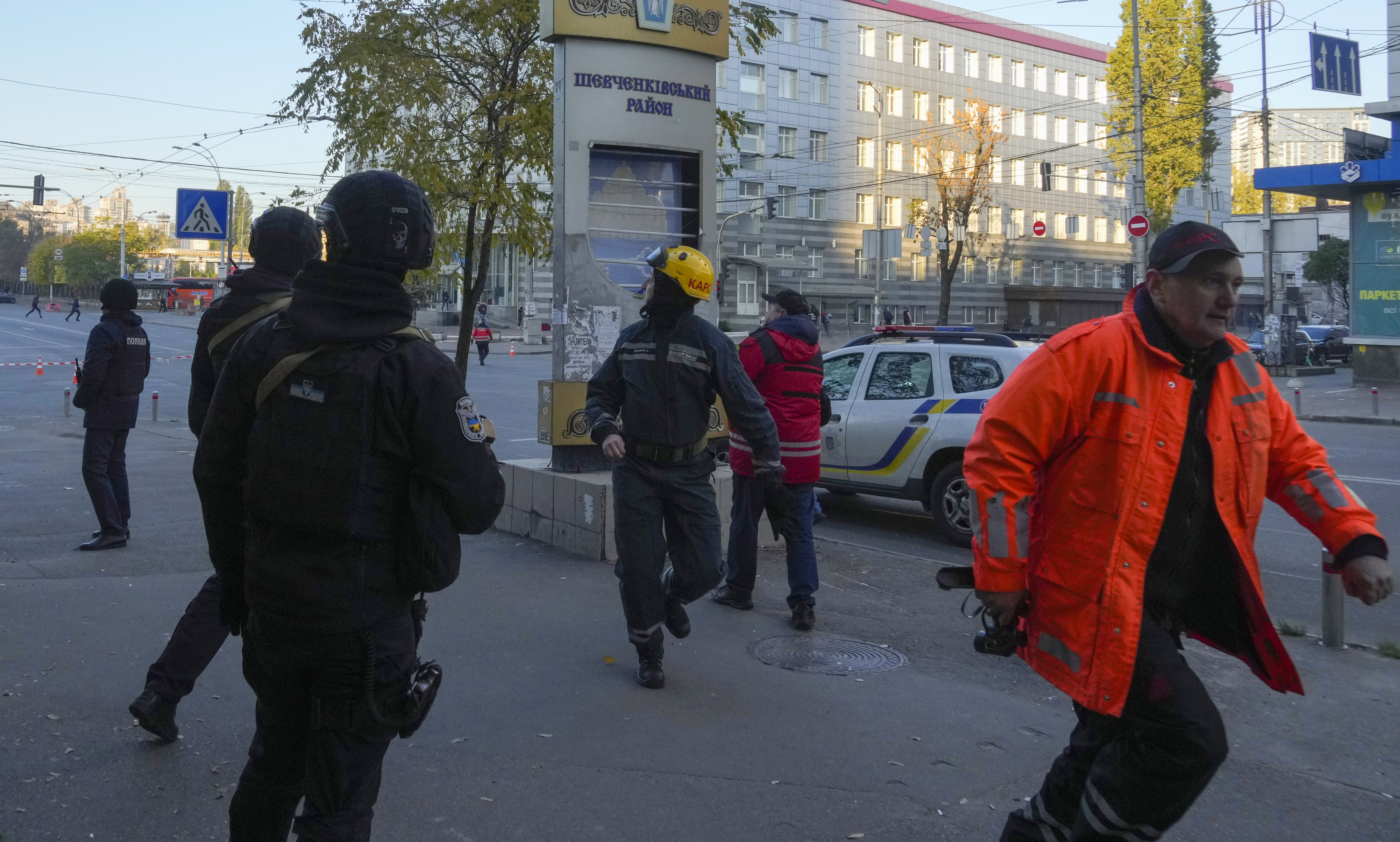 People react as a drone fires on buildings in Kyiv, Ukraine, Monday.