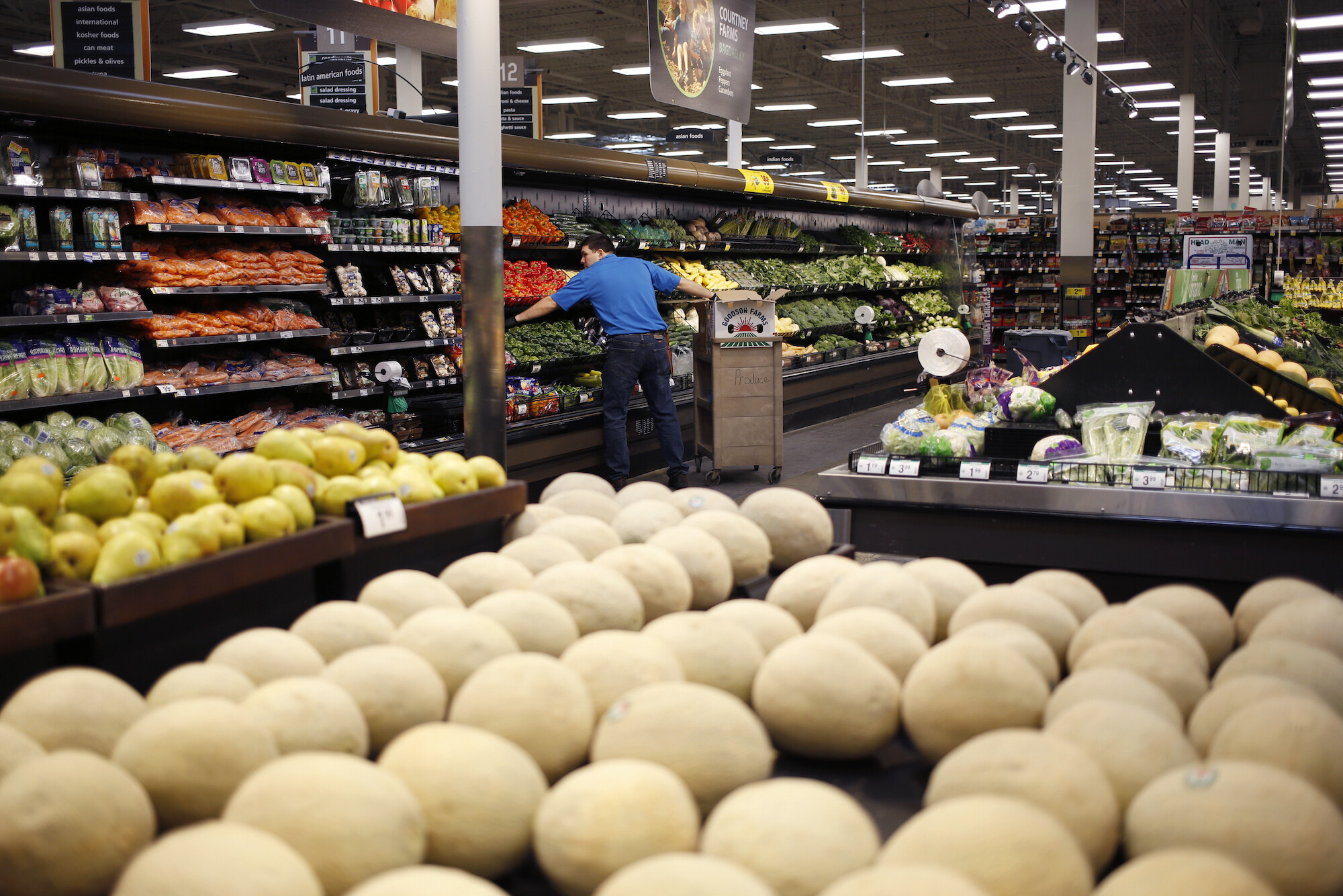 An employee restocks vegetables at a Kroger Co. supermarket in Louisville, Kentucky, U.S., on Tuesday, March 5, 2019.