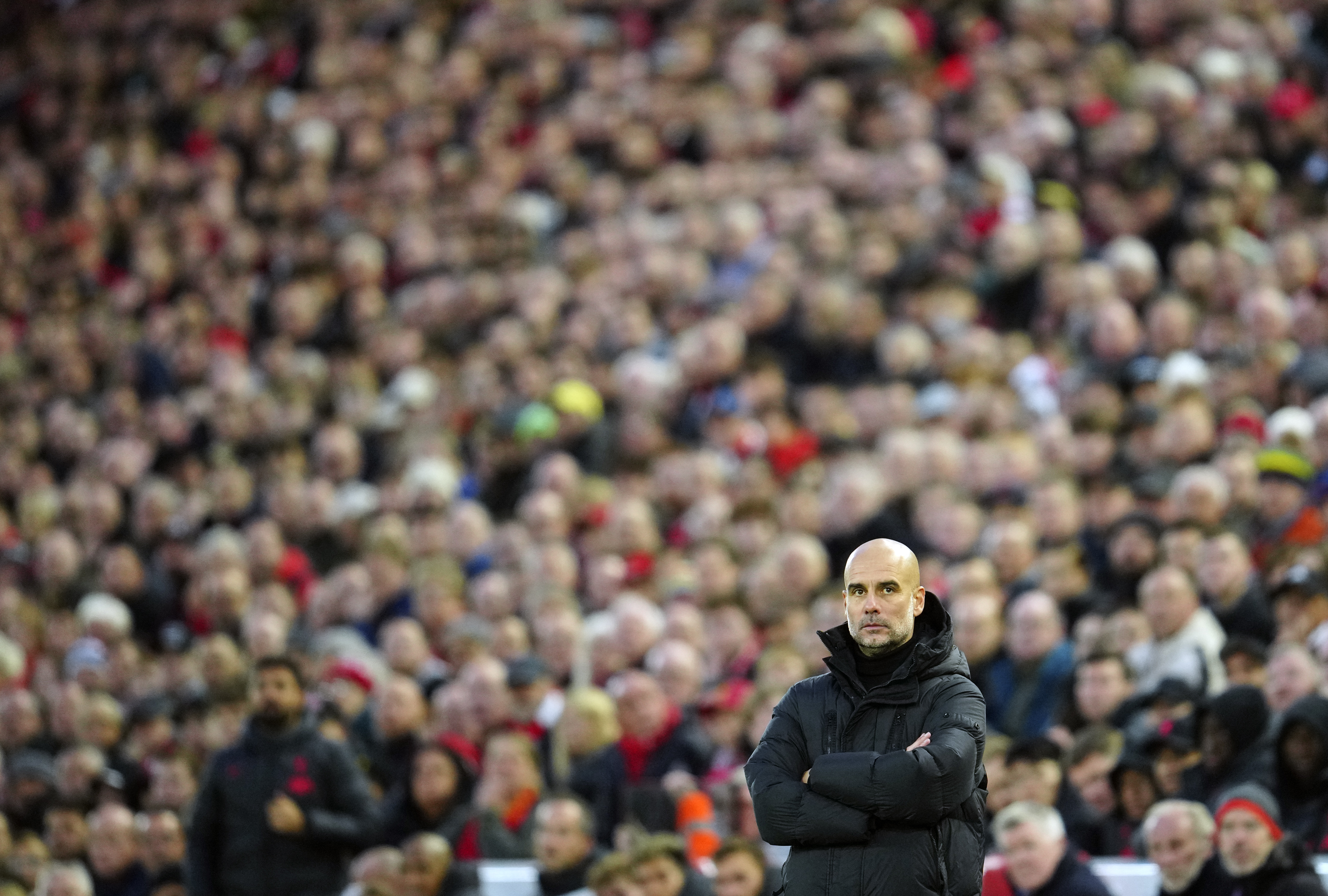 Manchester City's head coach Pep Guardiola looks out during the English Premier League soccer match between Liverpool and Manchester City at Anfield stadium in Liverpool, Sunday, Oct. 16, 2022. 