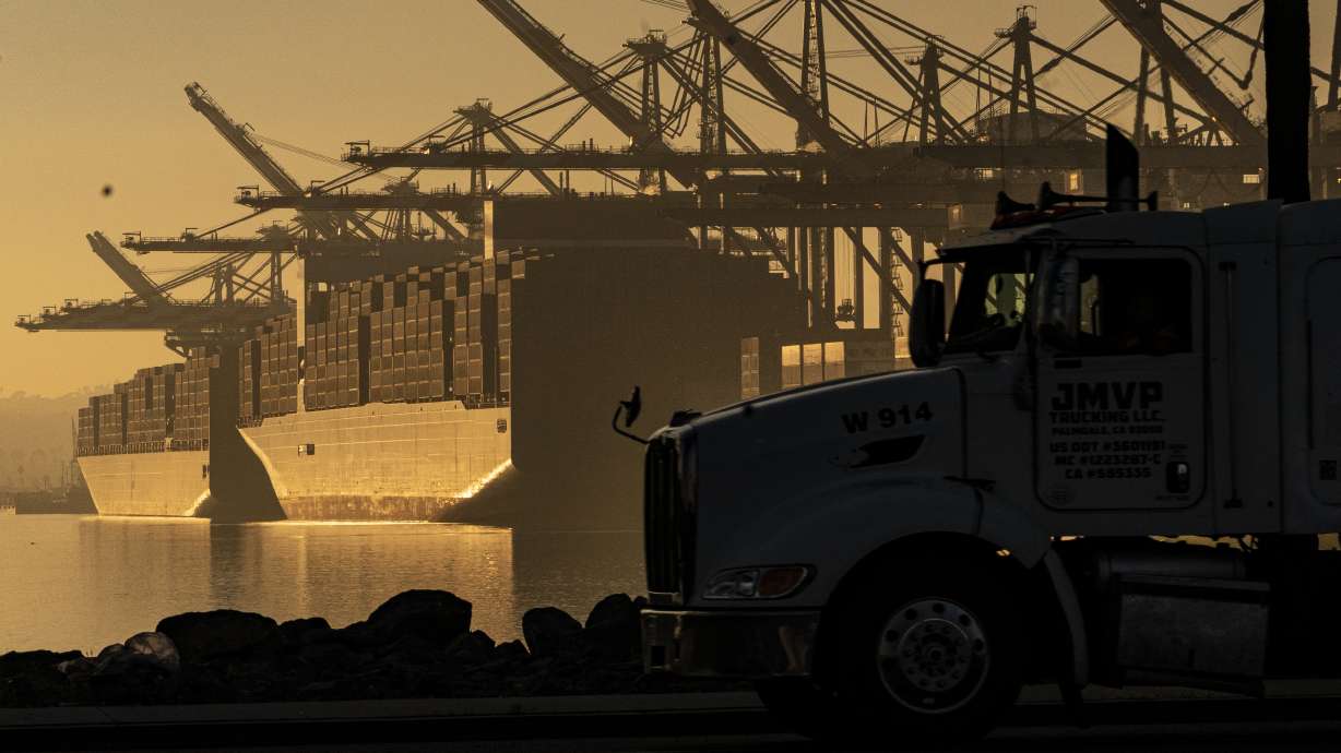A truck arrives to pick up a shipping container near vessels at the Port of Los Angeles, on Nov. 30, 2021. An influential government advisory panel comprised of major U.S. businesses is proposing new rules that would roll back already limited public access to import data.