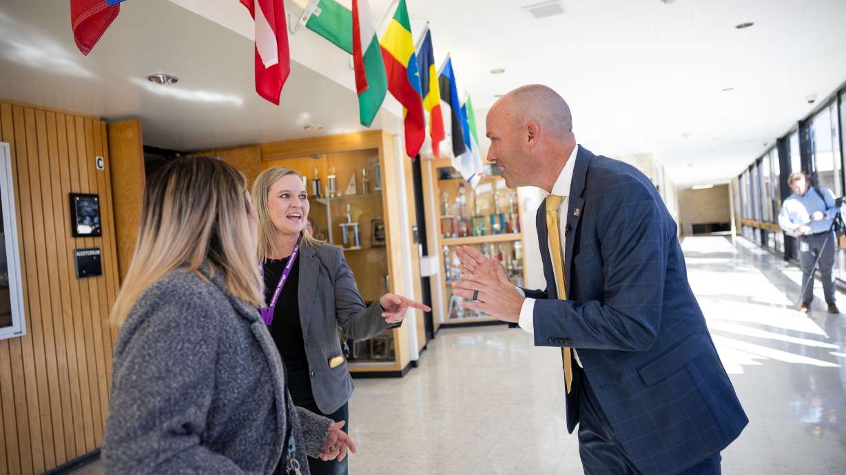 Stacy Wood, a school counselor at Bonneville Jr. High School, and principal Jen Johnson thank Utah Gov. Spencer Cox after he spoke to a group of teachers and parents about the effects of social media on teens’ mental health at the school, in Holladay, on Monday.