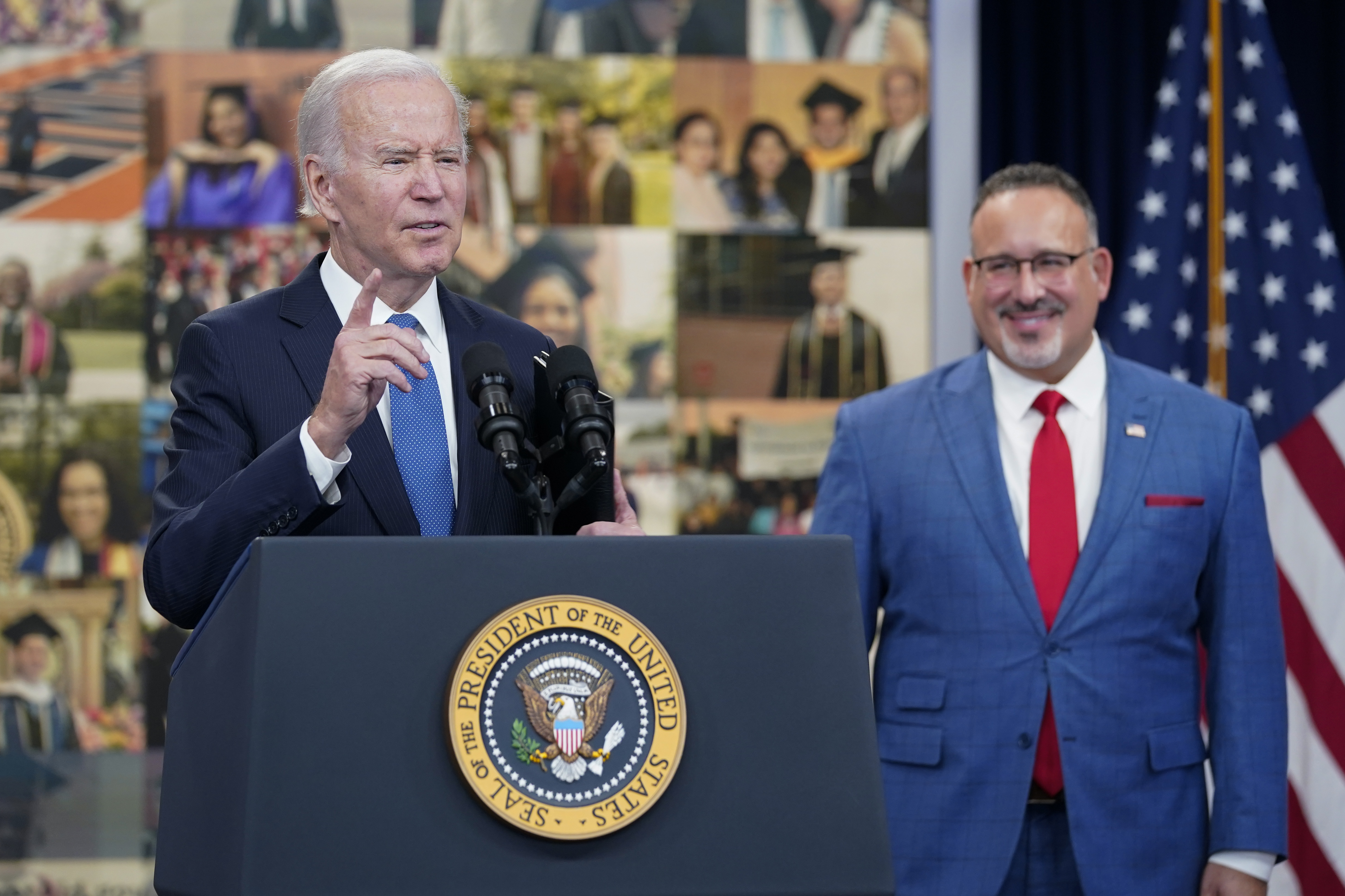 President Joe Biden speaks about the student debt relief portal beta test as Education Secretary Miguel Cardona listens in the South Court Auditorium on the White House complex in Washington, Monday.