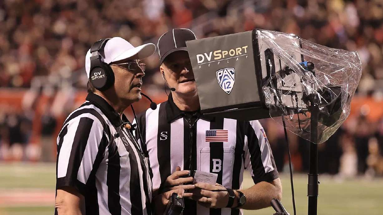 Officials at the Utah-USC game watch a replay review on Oct. 15, 2022.