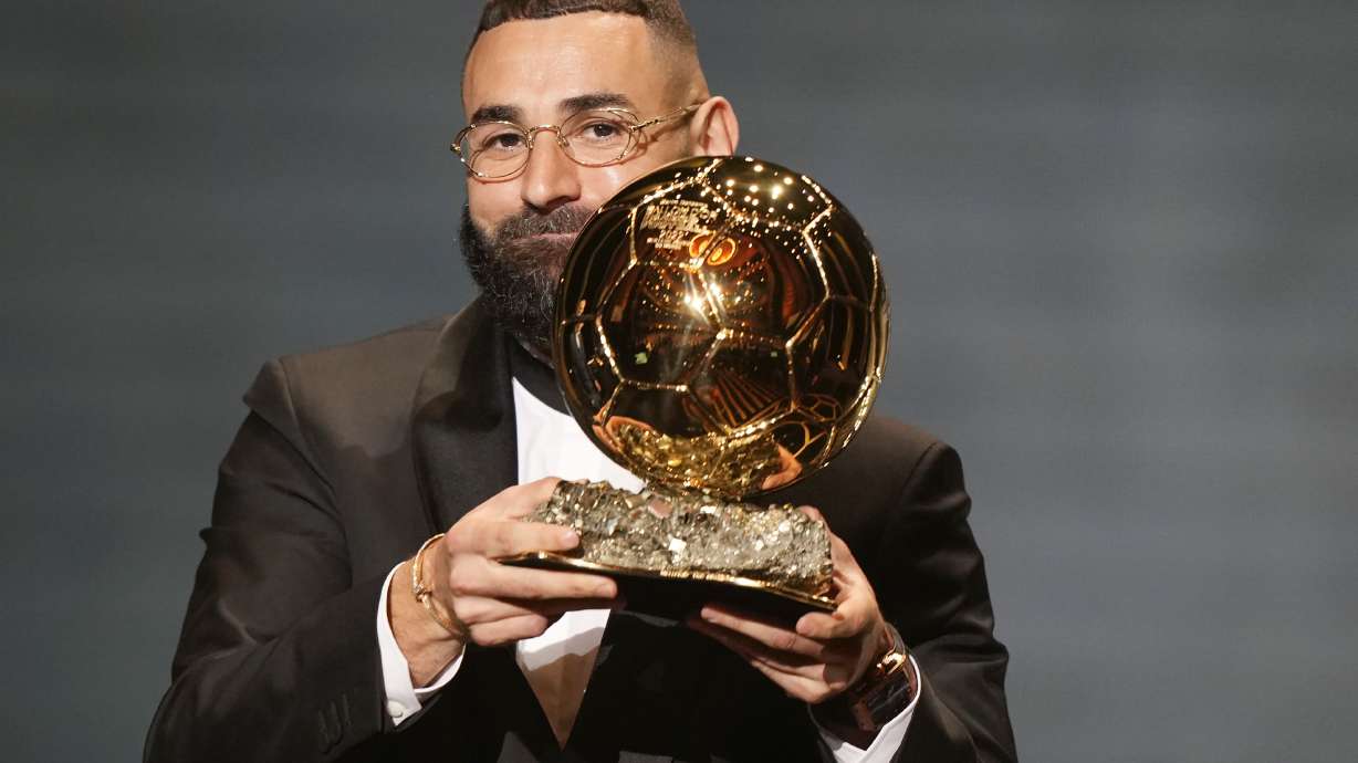 Real Madrid's Karim Benzema celebrates after winning the 2022 Ballon d'Or trophy during the 66th Ballon d'Or ceremony at Theatre du Chatelet in Paris, France, Monday, Oct. 17, 2022.