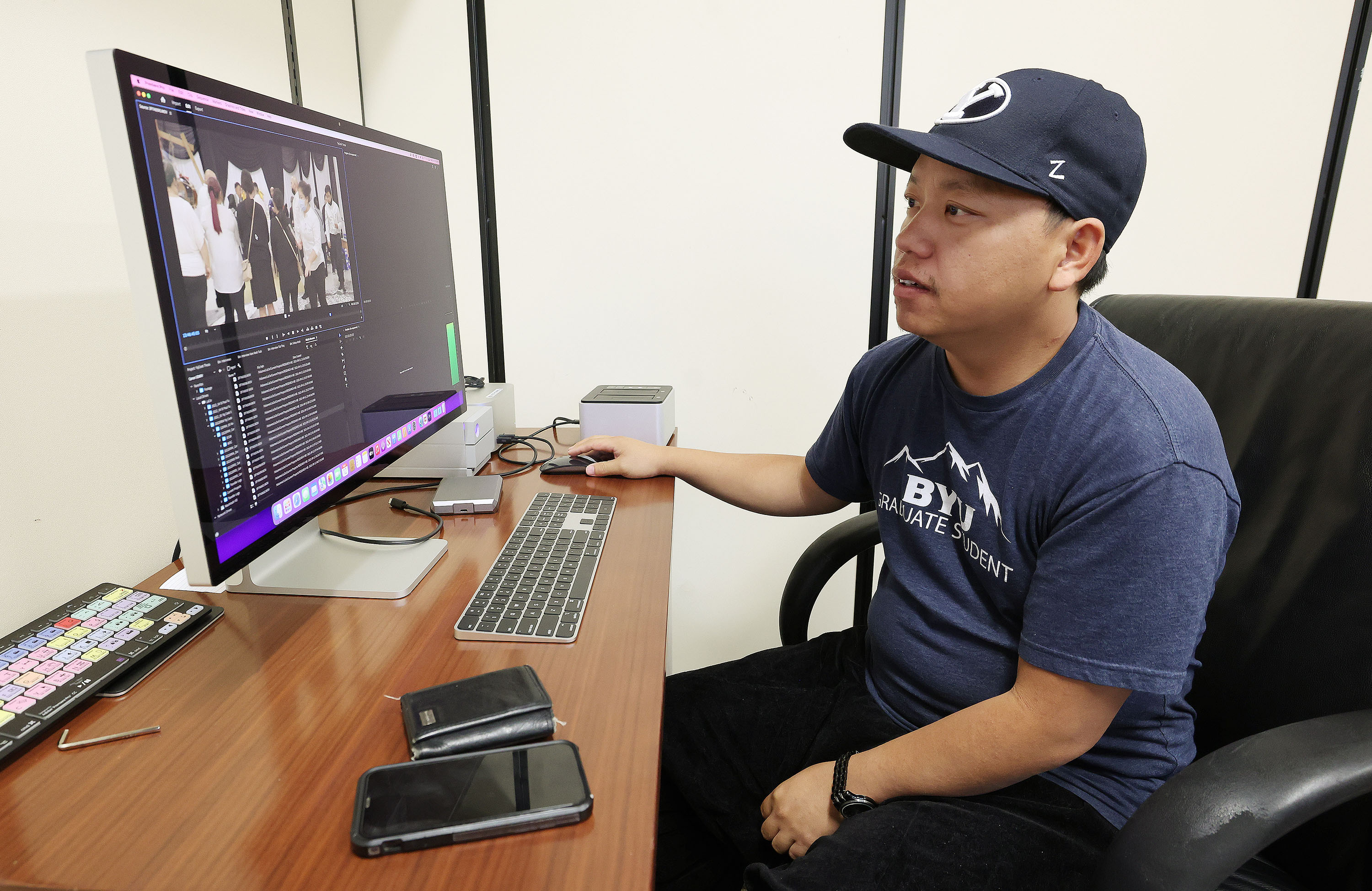 Yang Vang, a Brigham Young University master's degree candidate in anthropology and world-renowned Hmong shaman, works on his thesis project on campus in Provo on Thursday, Oct. 13.