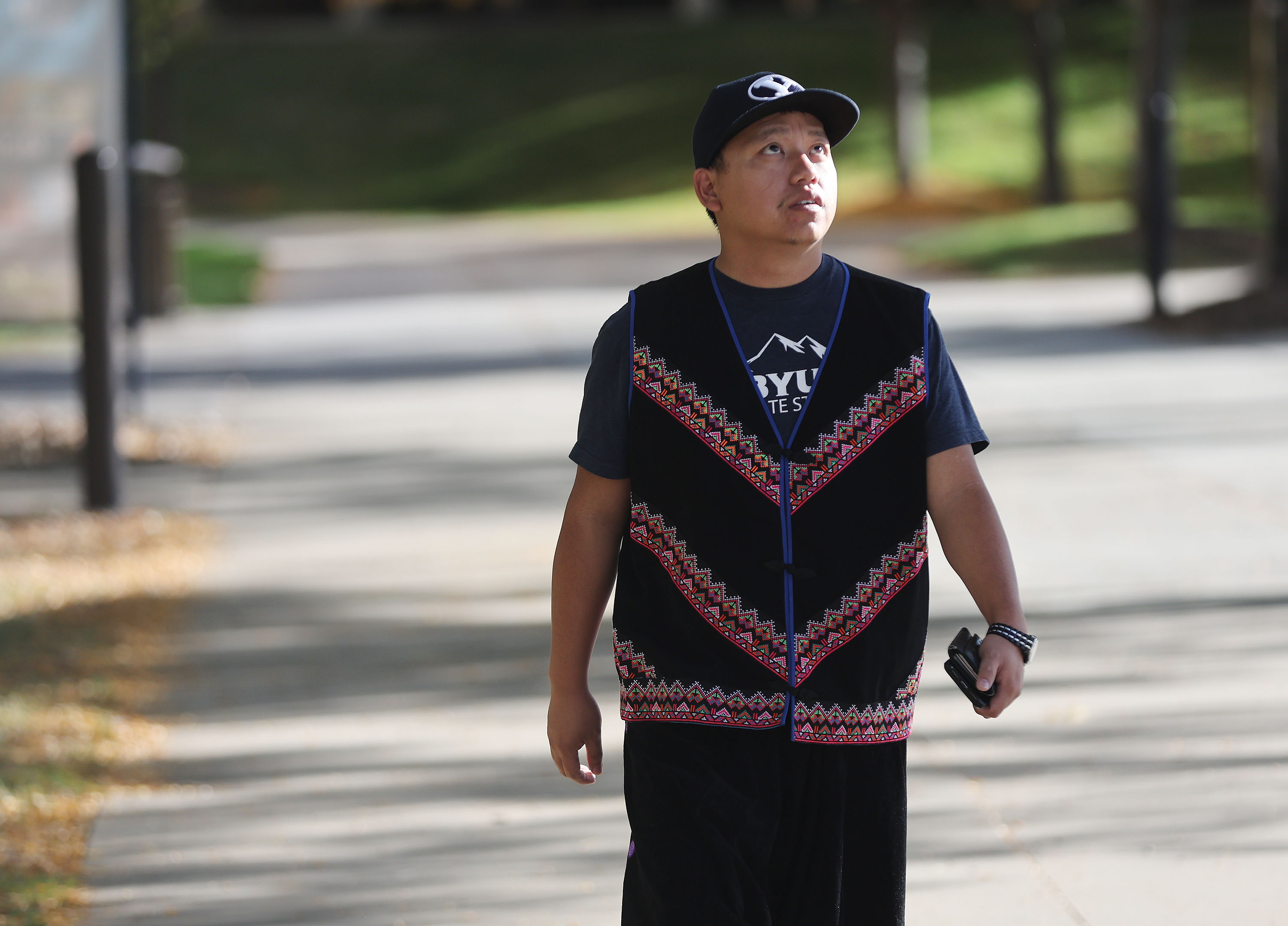 Yang Vang, a Brigham Young University master's degree candidate in anthropology, walks on campus in Provo on Oct. 13. Vang is also a world-renowned Hmong shaman.