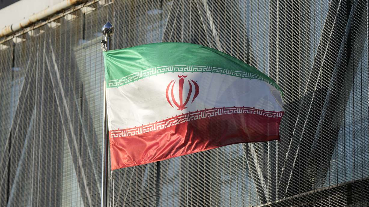 Iran's national flag flutters at the Iran embassy in Seoul, South Korea, Tuesday, Oct. 18, 2022. An online post on the account of an Iranian female competitive climber offered an apology Tuesday after she appeared without a headscarf, or hijab, at an event in South Korea.