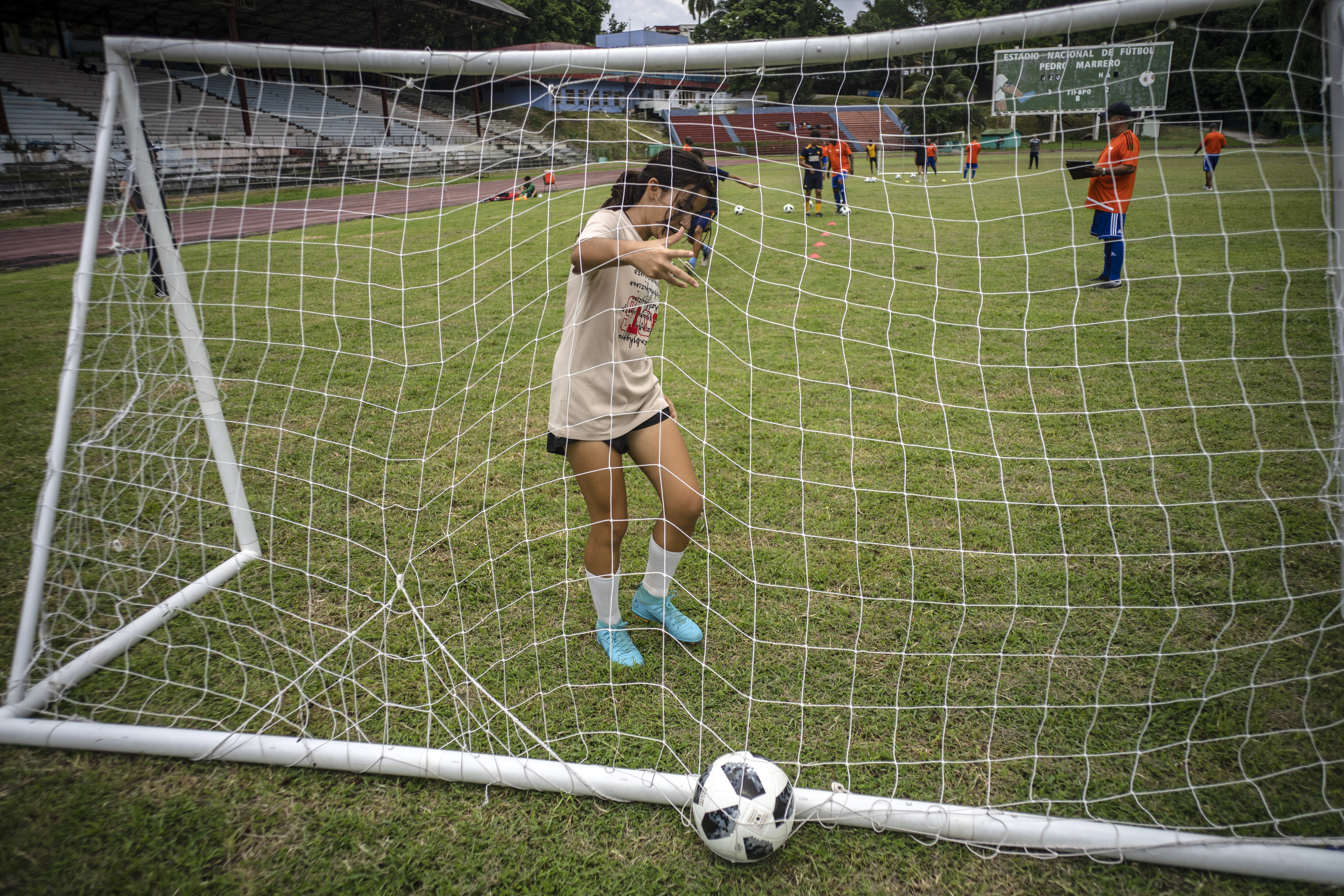 Gabriela Alfonso Cabrera trains at the Pedro Marrero stadium in Havana, Cuba, Wednesday, Sept. 14, 2022. Alfonso sometimes is still the only girl playing alongside boys who are bigger and stronger than her, but she is not quitting after having waited four years to share a field with them. 