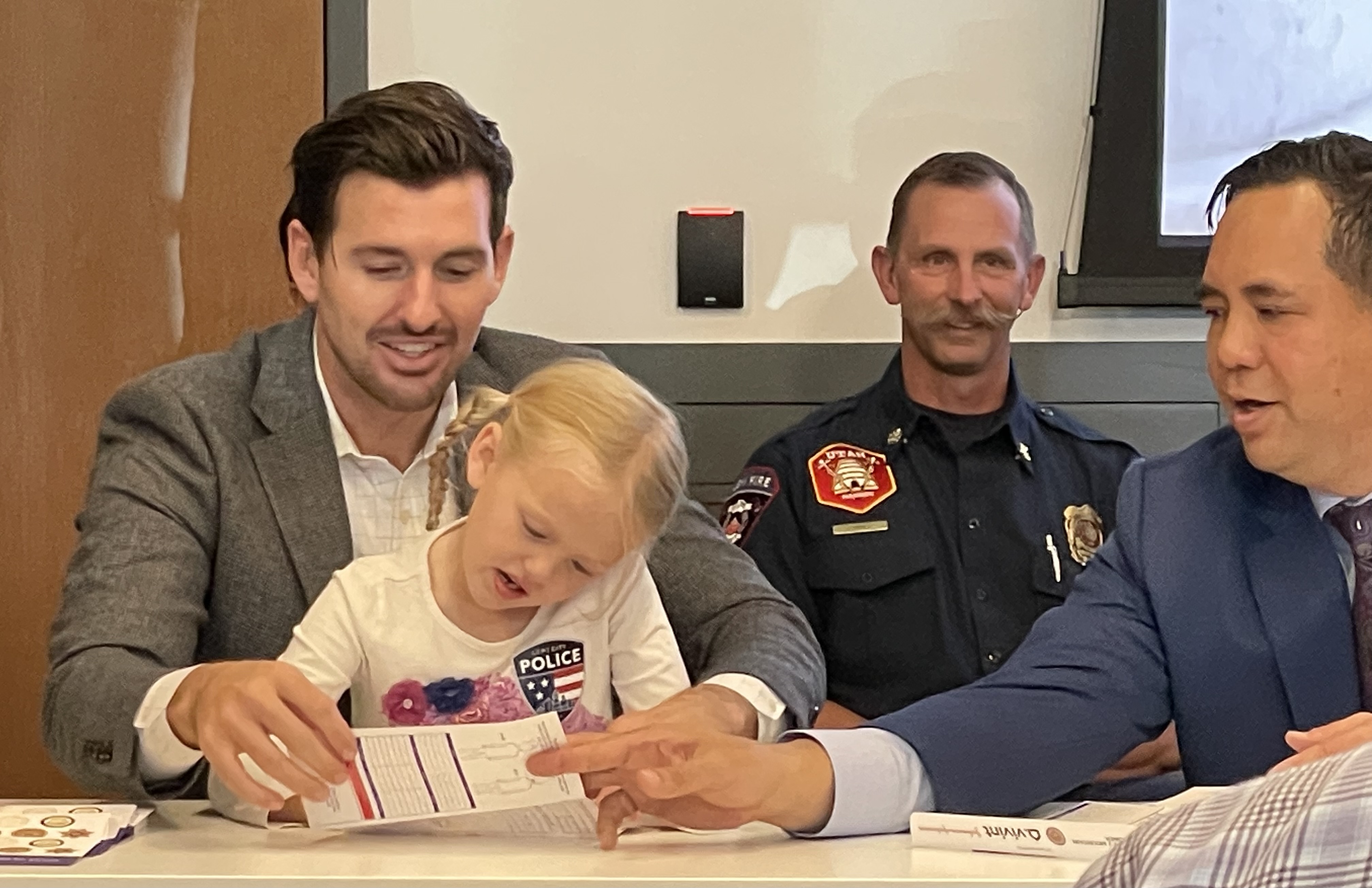 Marlon Bateman and his daughter, 6, demonstrate how to complete a child ID kit along with Utah Attorney General Sean Reyes in Lehi on Tuesday. 