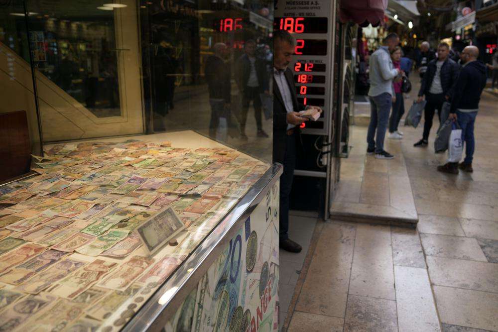 A man holds bank notes as he leaves a currency exchange shop in Istanbul, Turkey, Oct. 14. As the value of the U.S. dollar soars, other currencies around the world are sinking by comparison.